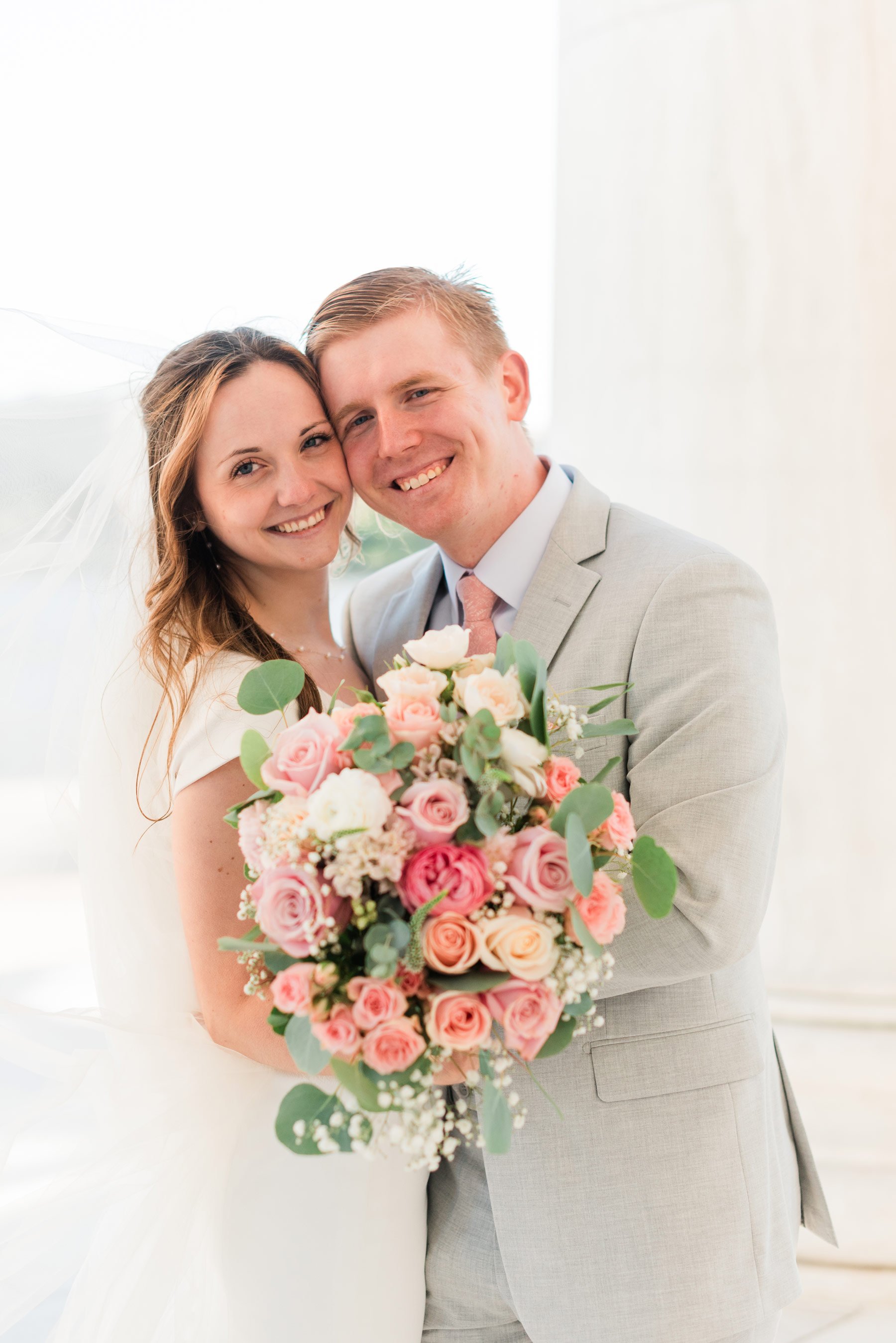    The bride’s bouquet is full of pink and white roses with a few sprigs of baby’s breath. #washingtondcphotography #washingtondctemple #washingtondcwedding #dcweddingphotographer #washingtondctemplewedding #eastcoastweddingphotographer #sunsetbridal