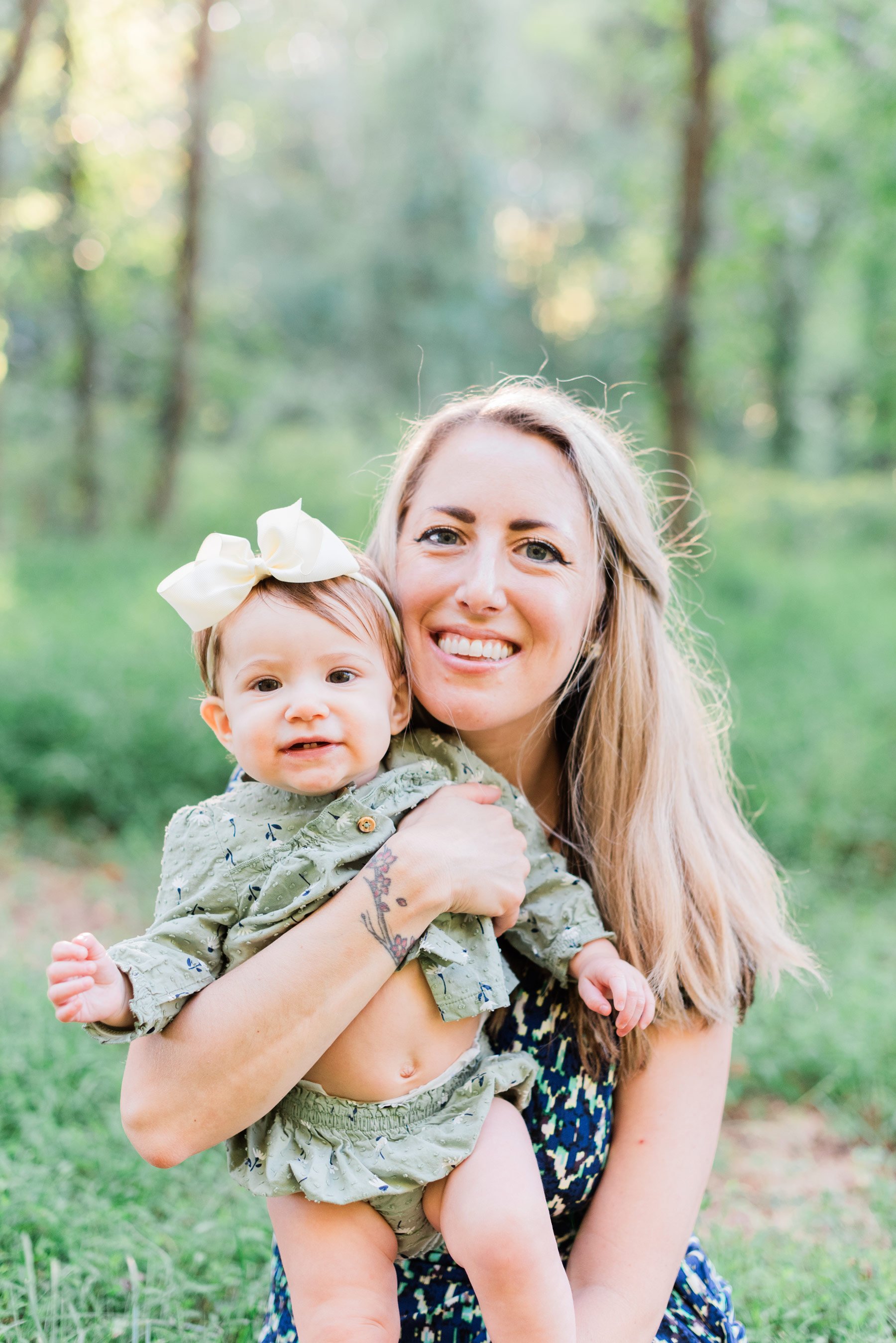    A Georgia mom and daughter smile for the camera with green grass in the background. #peachtreecityphotographer #familyphotographersenoia #outdoorfamilyphotos #familyphotoswithkids #fayettevillefamilyphotographer #fallfamilyphotographer #georgiafam