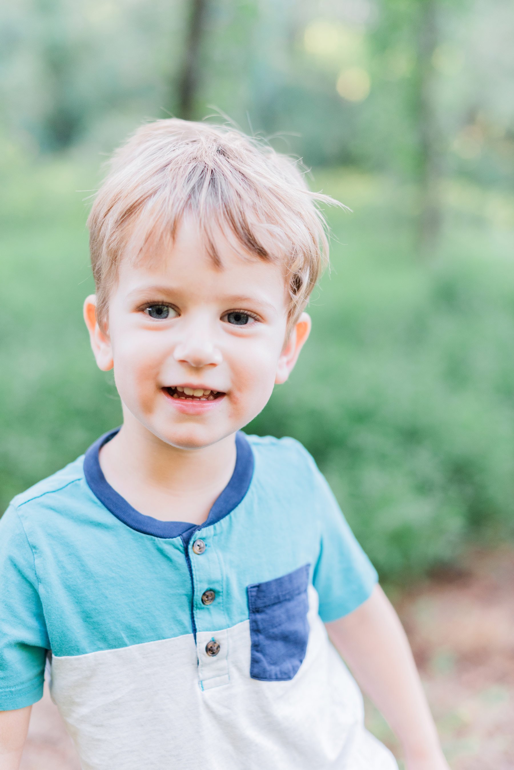    Big brother smiles for his portrait in a blue color block henley shirt. #peachtreecityphotographer #familyphotographersenoia #outdoorfamilyphotos #familyphotoswithkids #fayettevillefamilyphotographer #fallfamilyphotographer #georgiafamilyphotograp