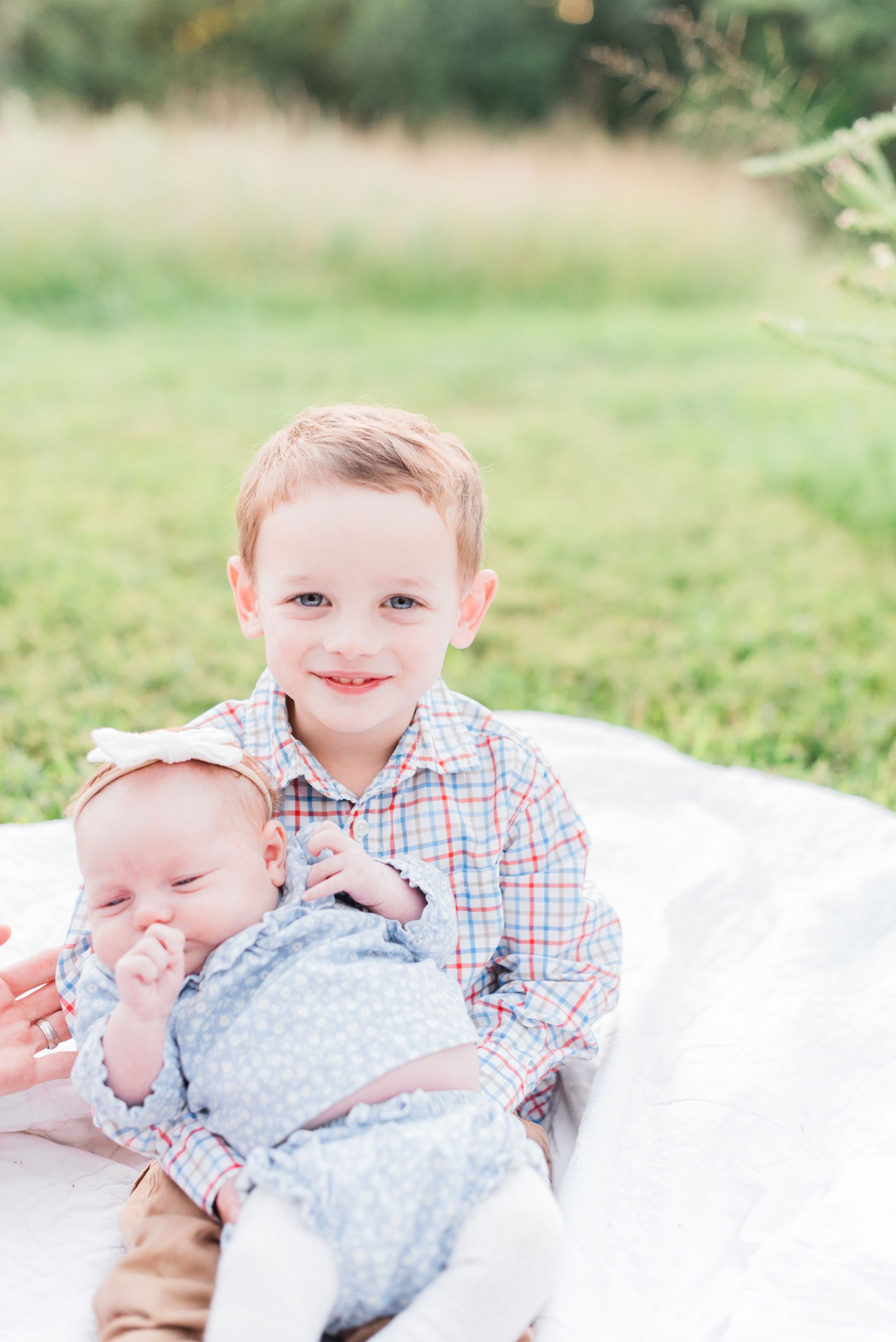    These sweet little siblings smile for a portrait in the green maryland grass. #marylandfamilyphotographer #findingafamilyphotographer #familyphotooutfits #semiformalphotooutfits #outdoorfamilysession #photoswithkids #georgiafamilyphotos #siblingph