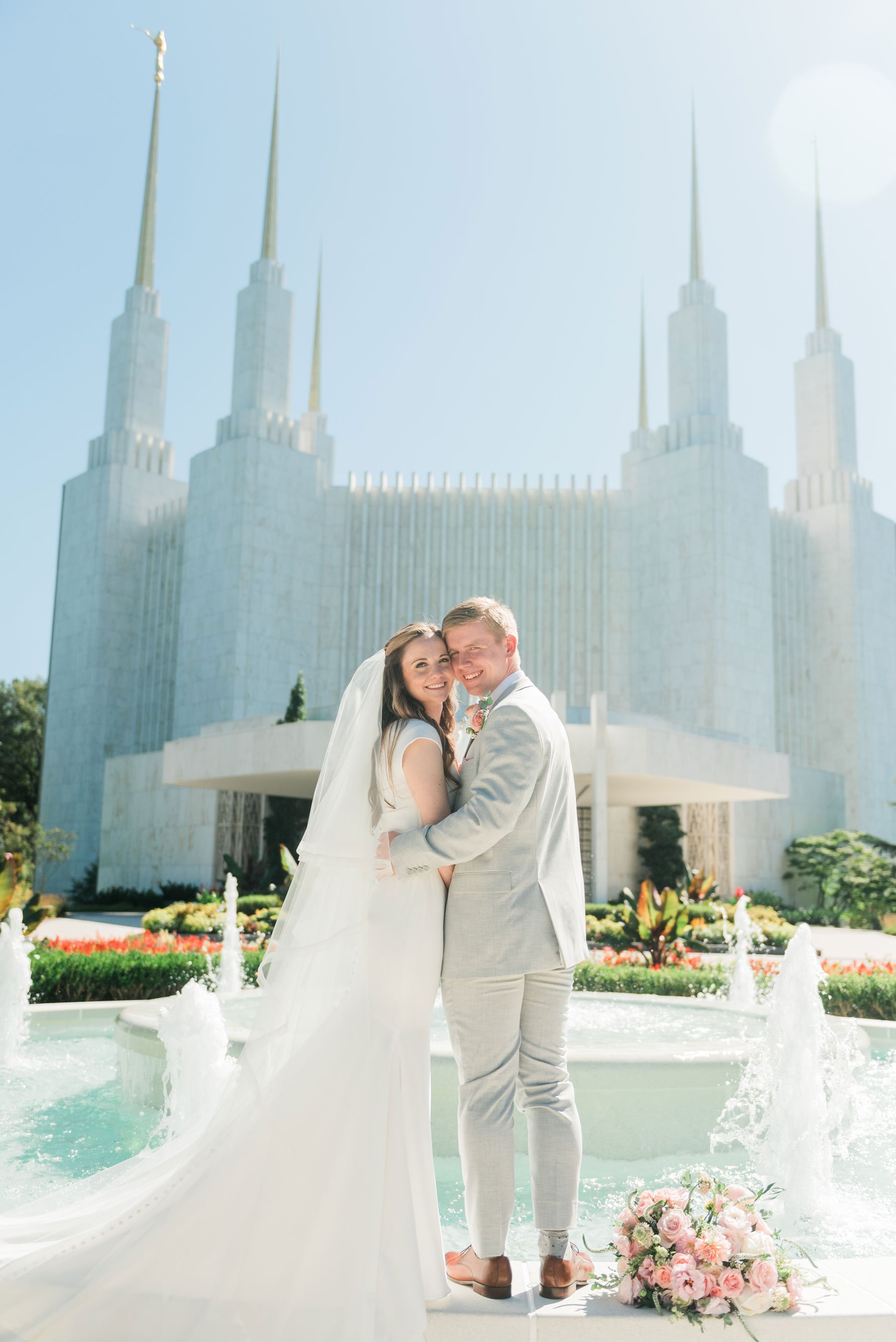    The washington d.c. LDS temple shines in this wedding day portrait in front of the fountain. #washingtondctemple #washingtondcweddingphotographer #dcwedding #pinkwedding #ldsweddingphotographer #pinkweddingbouquet #washingtondctempleexit #eastcoas