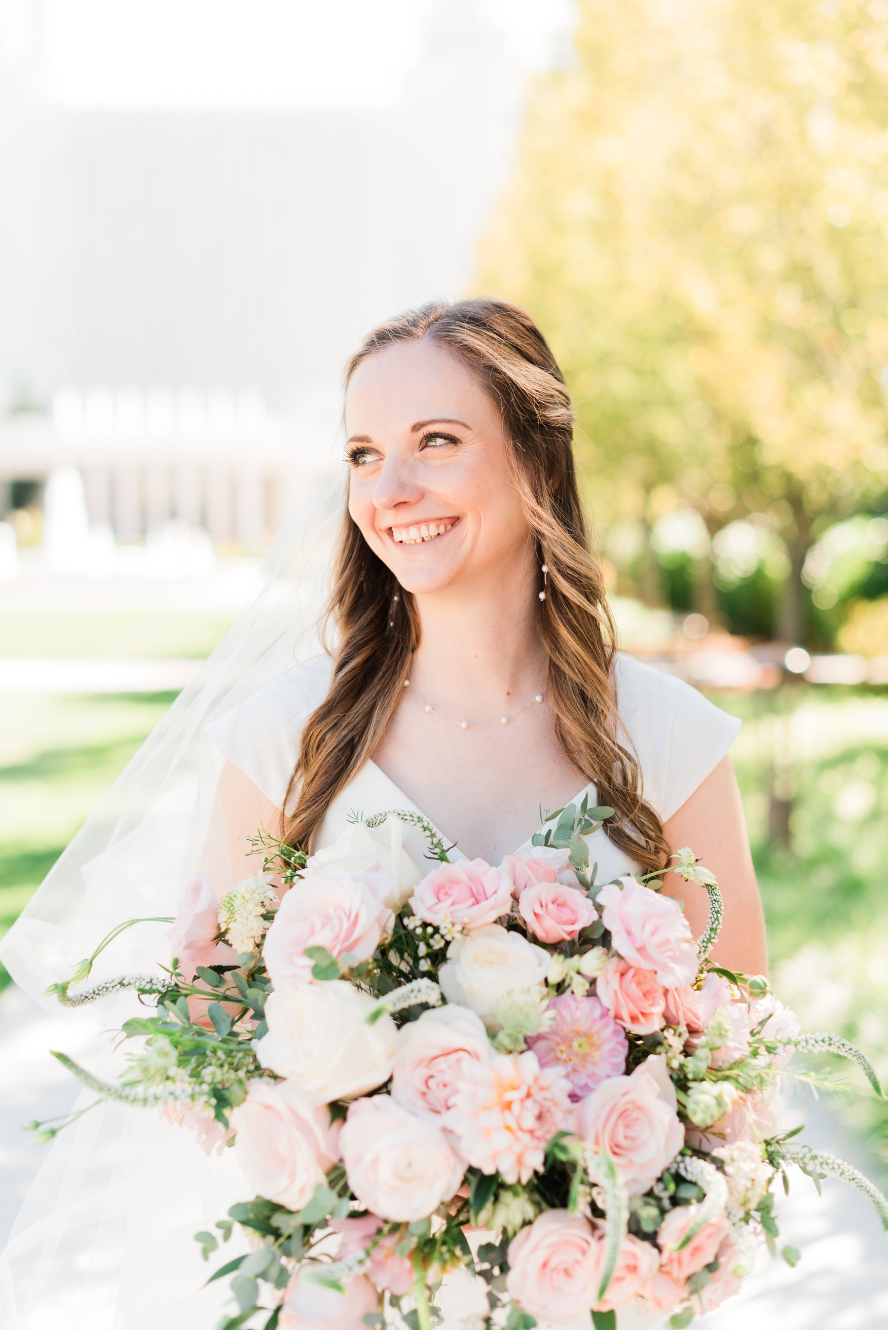    This gorgeous bride smiles for a portrait with her breathtaking bouquet full of blush roses. #washingtondctemple #washingtondcweddingphotographer #dcwedding #pinkwedding #ldsweddingphotographer #pinkweddingbouquet #washingtondctempleexit #eastcoas