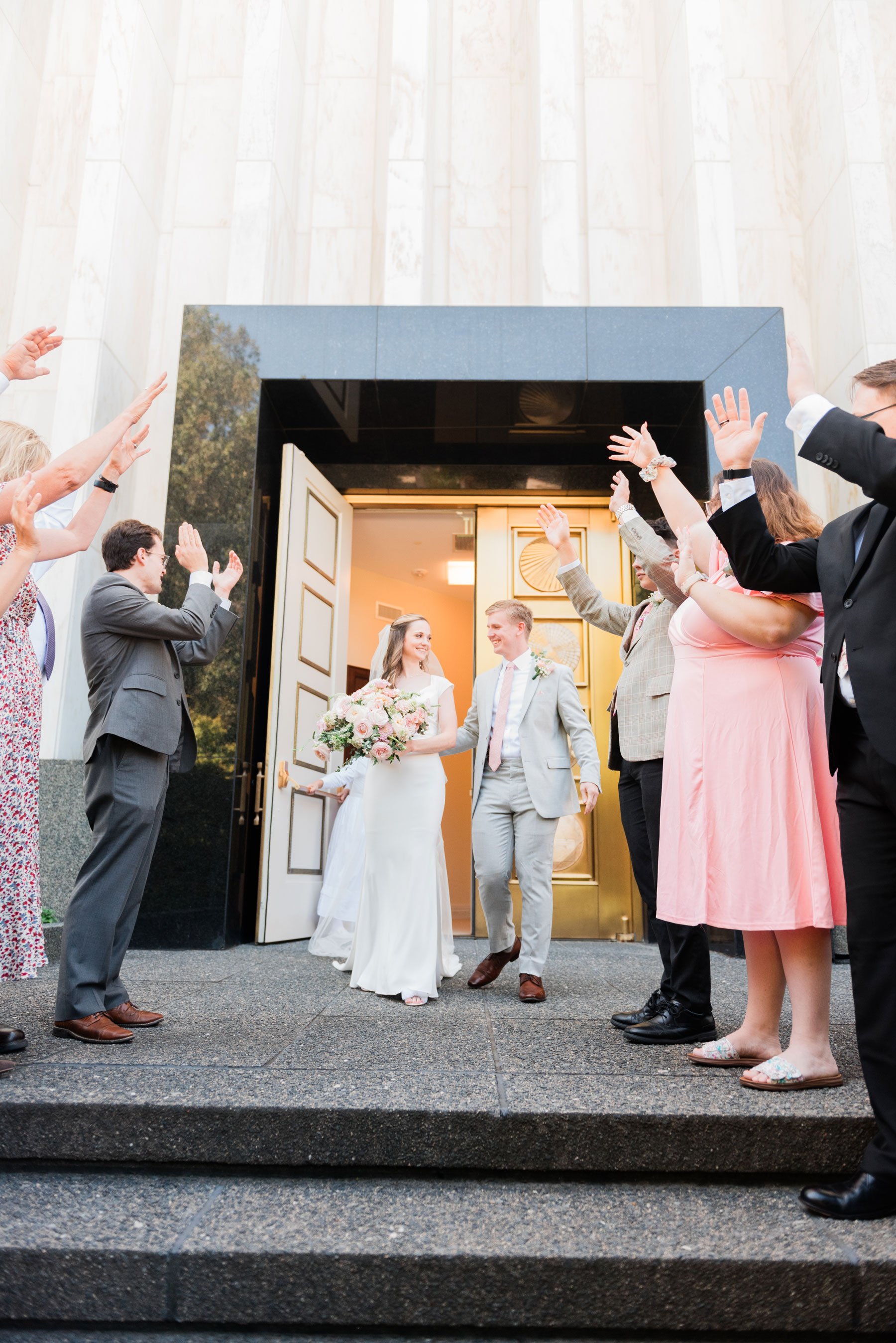    Family and friends cheer as the newly married couple exits the washington d.c. temple doors. #washingtondctemple #washingtondcweddingphotographer #dcwedding #pinkwedding #ldsweddingphotographer #pinkweddingbouquet #washingtondctempleexit #eastcoas
