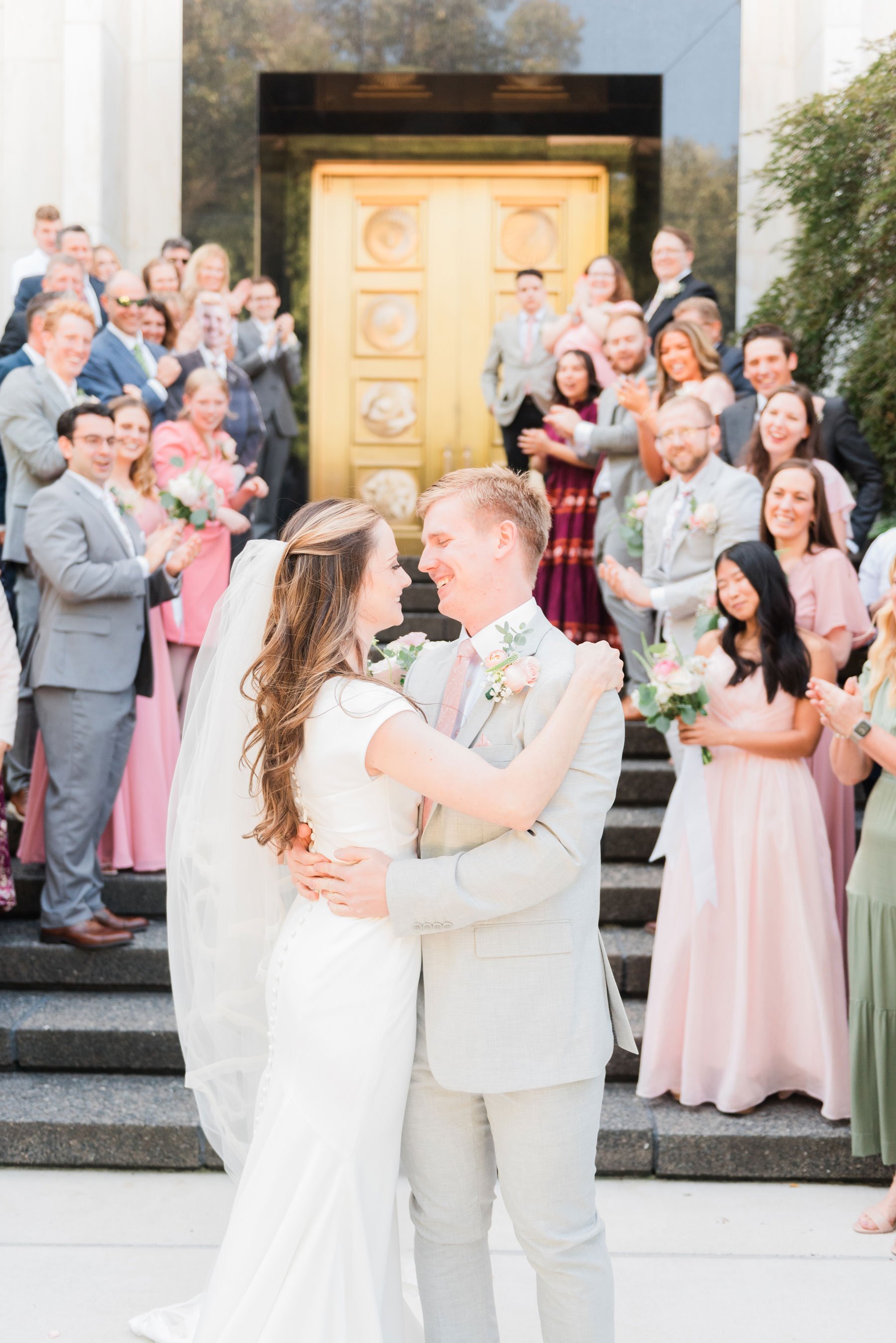    The loved ones of the bride and groom stand for a group photo outside of the temple doors. #washingtondctemple #washingtondcweddingphotographer #dcwedding #pinkwedding #ldsweddingphotographer #pinkweddingbouquet #washingtondctempleexit #eastcoastw