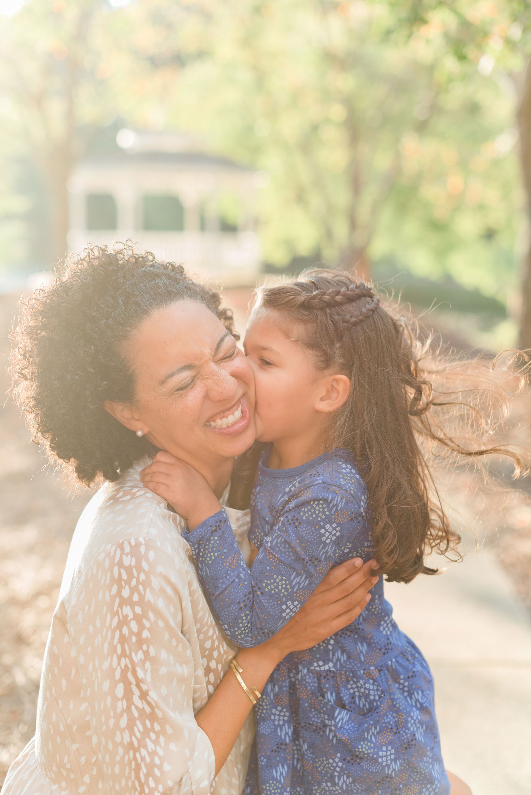    Little Eva gives her mom a kiss on the cheek in this candid mother-daughter photo. #candidfamilyphotos #atlantafamilyphotographer #familyphotoswithkids #familyoutfitinspo #confidentkids #kidsselfesteem # confidencetips #georgiafamilyphotos #georgi