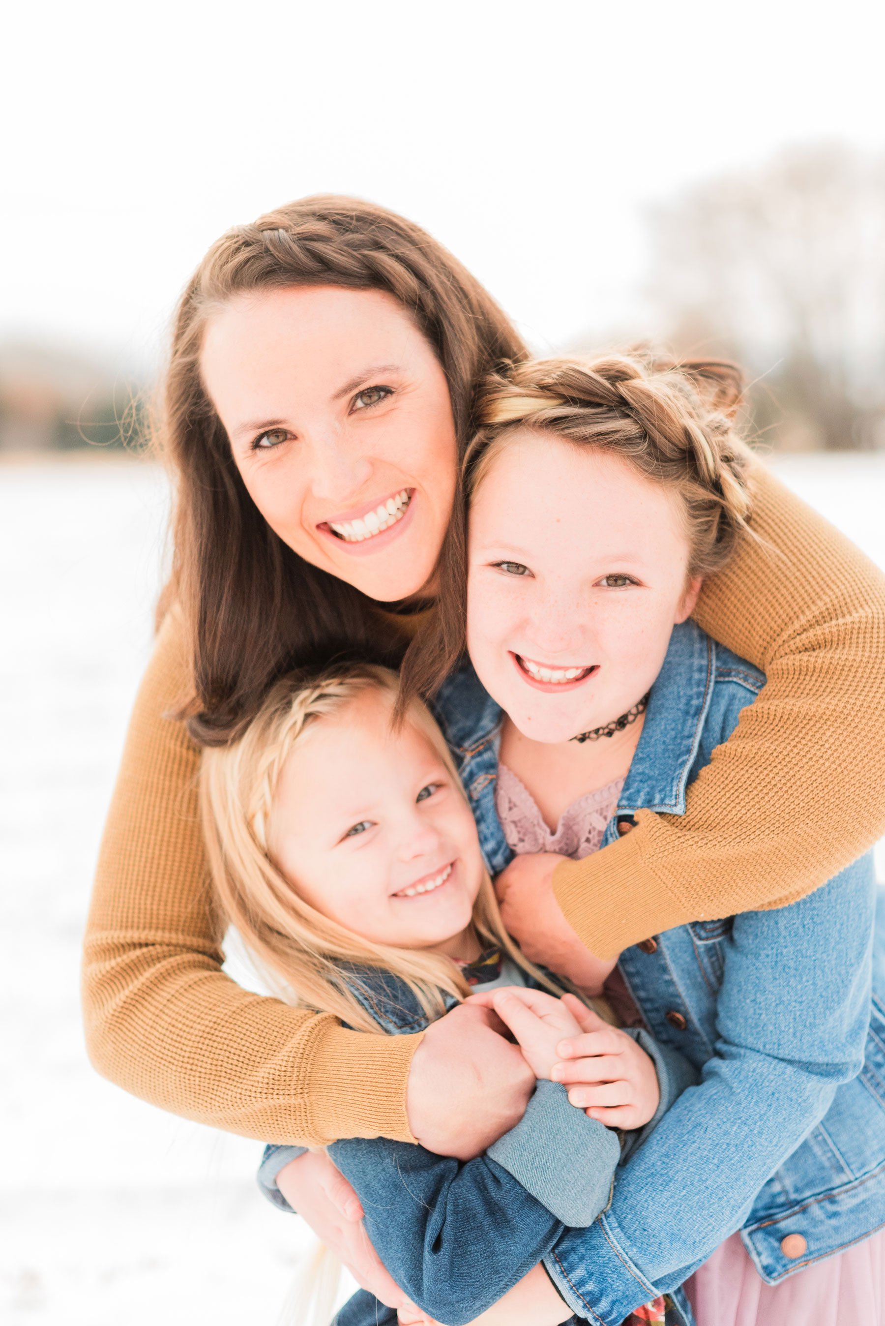  A mom hugs her two daughters and they all smile for the camera during a Mommy and Me photo session by Jacquie Erickson. Mother-daughter photos mini me mommy and me&nbsp; #motherdaughterphotos #FamilyPhotographyJourney #atlantafamilyphotographer&nbsp