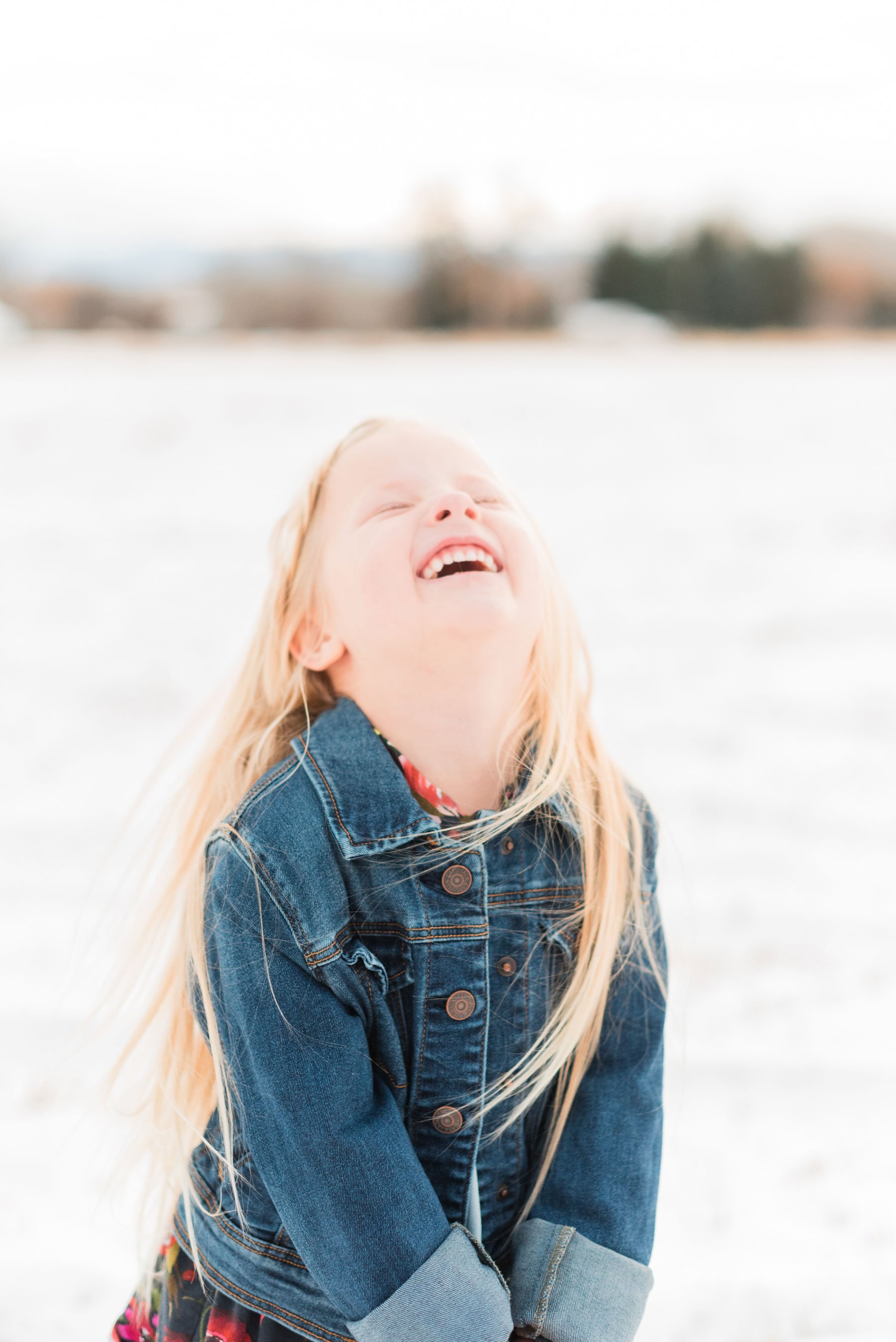  Jacquie Erickson, an Atlanta-based photographer captures a little girl looking up laughing as she stands in a snowy field. Mother-daughter photos mini me mommy and me&nbsp; #motherdaughterphotos #FamilyPhotographyJourney #atlantafamilyphotographer&n