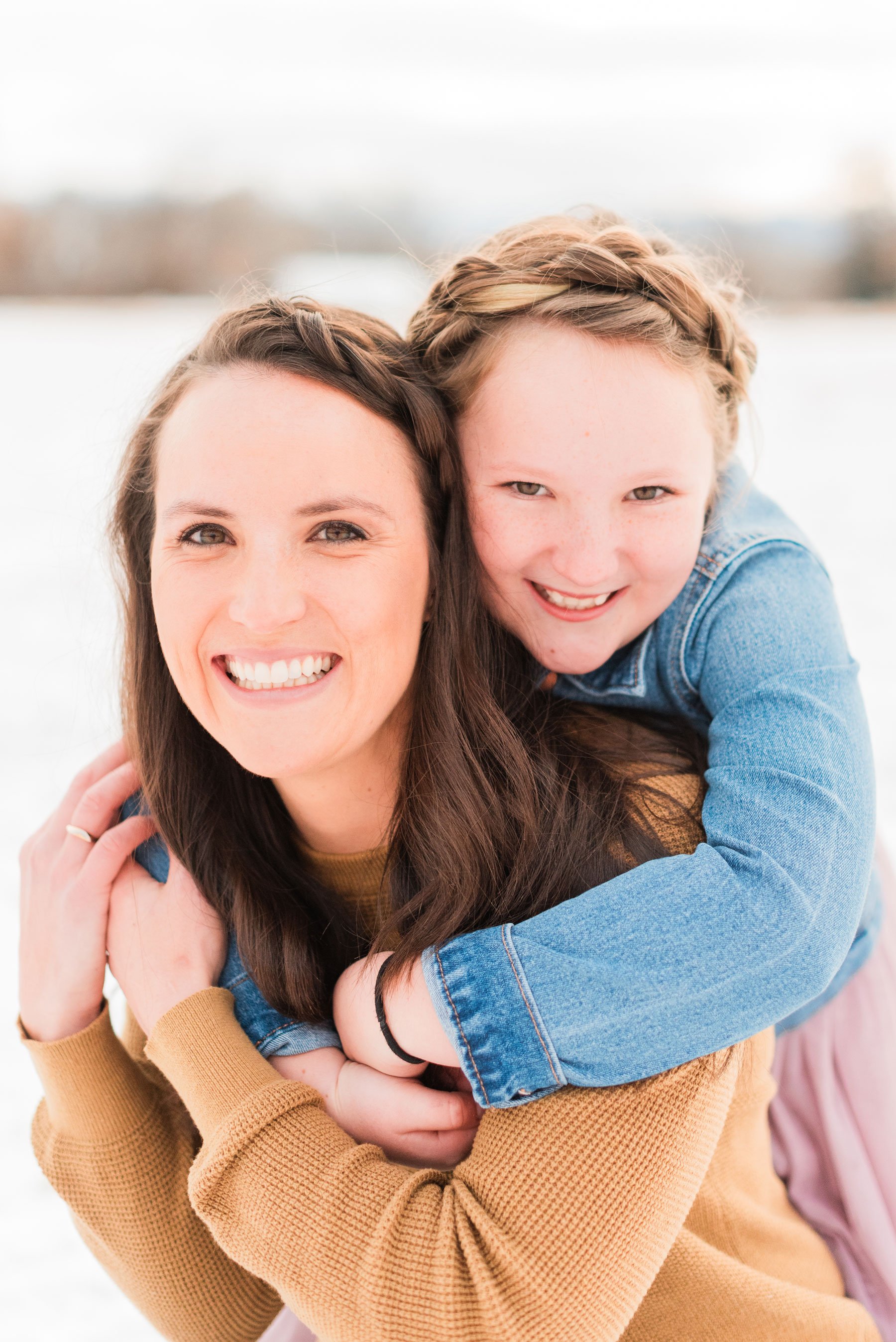  A ten-year-old daughter holds onto her mother's back and smiles over her shoulder in a mommy and me photo shoot by Jacquie Erickson.&nbsp; Genuine moments beautiful relationship #motherdaughterphotos #FamilyPhotographyJourney #atlantafamilyphotograp