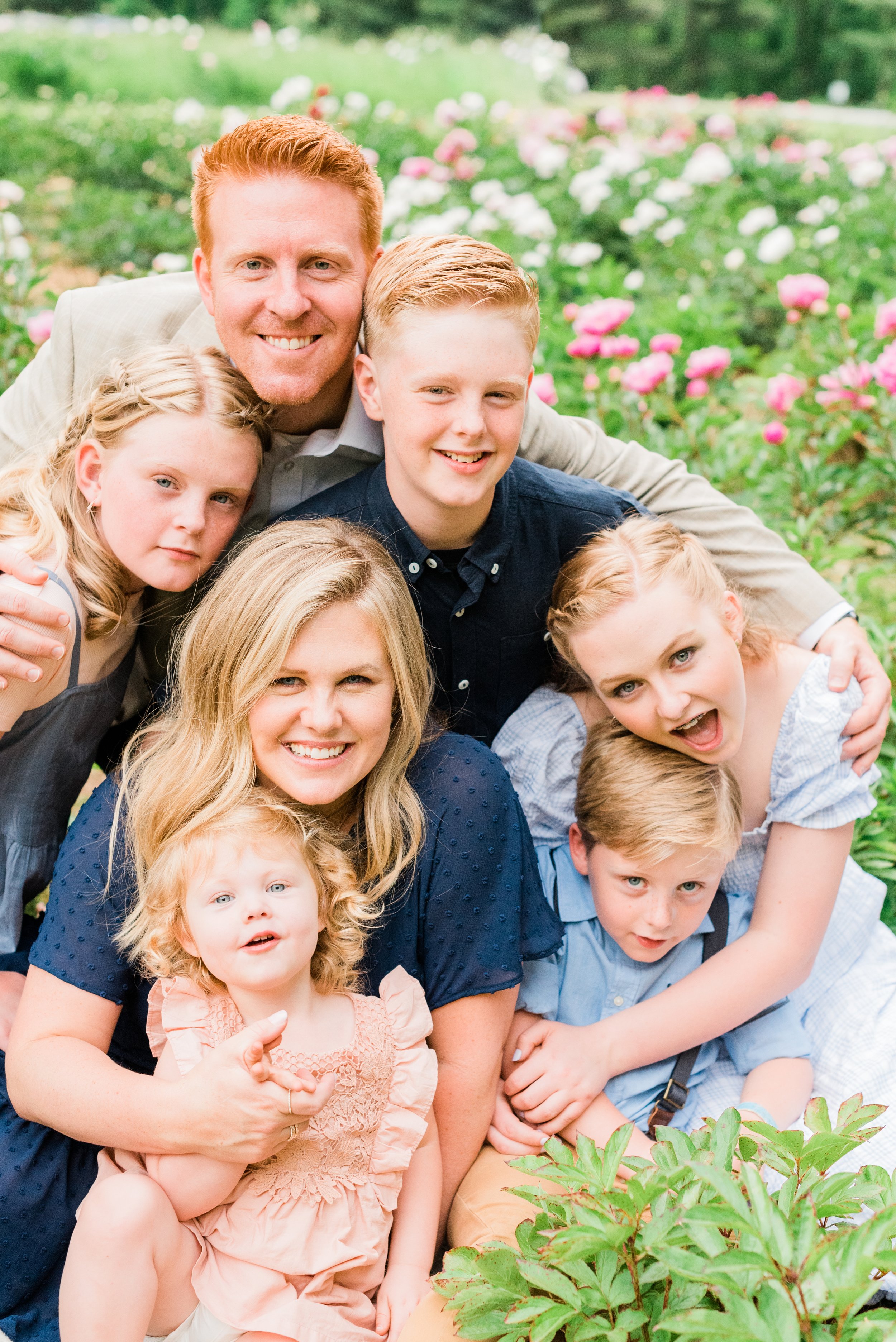  A family of seven smiles and makes faces at the camera during a family photo shoot by Jacquie Erickson. Capturing personality personalized photoshoot #atlantafamilyphotographer #familiesofinstagram #familypics #GeorgiaFamilyPhotographer 