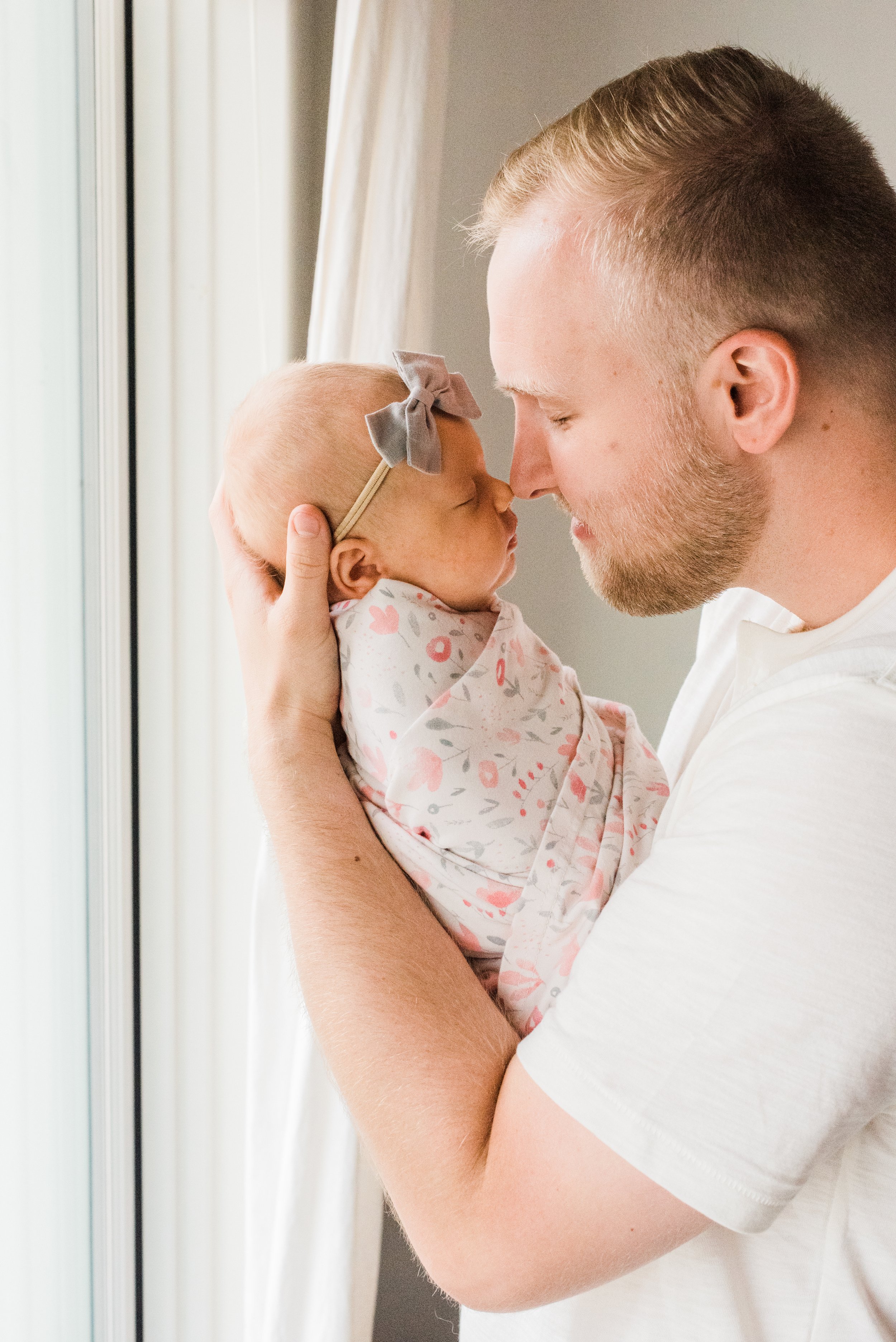  A father holds his newborn daughter and touches noses in this precious moment captured by Atlanta-based photographer, Jacquie Erickson. Newborn photo session DIY newborn photos Senoia, GA #naturallight #newbornphotographytips #diyphotography #mompho