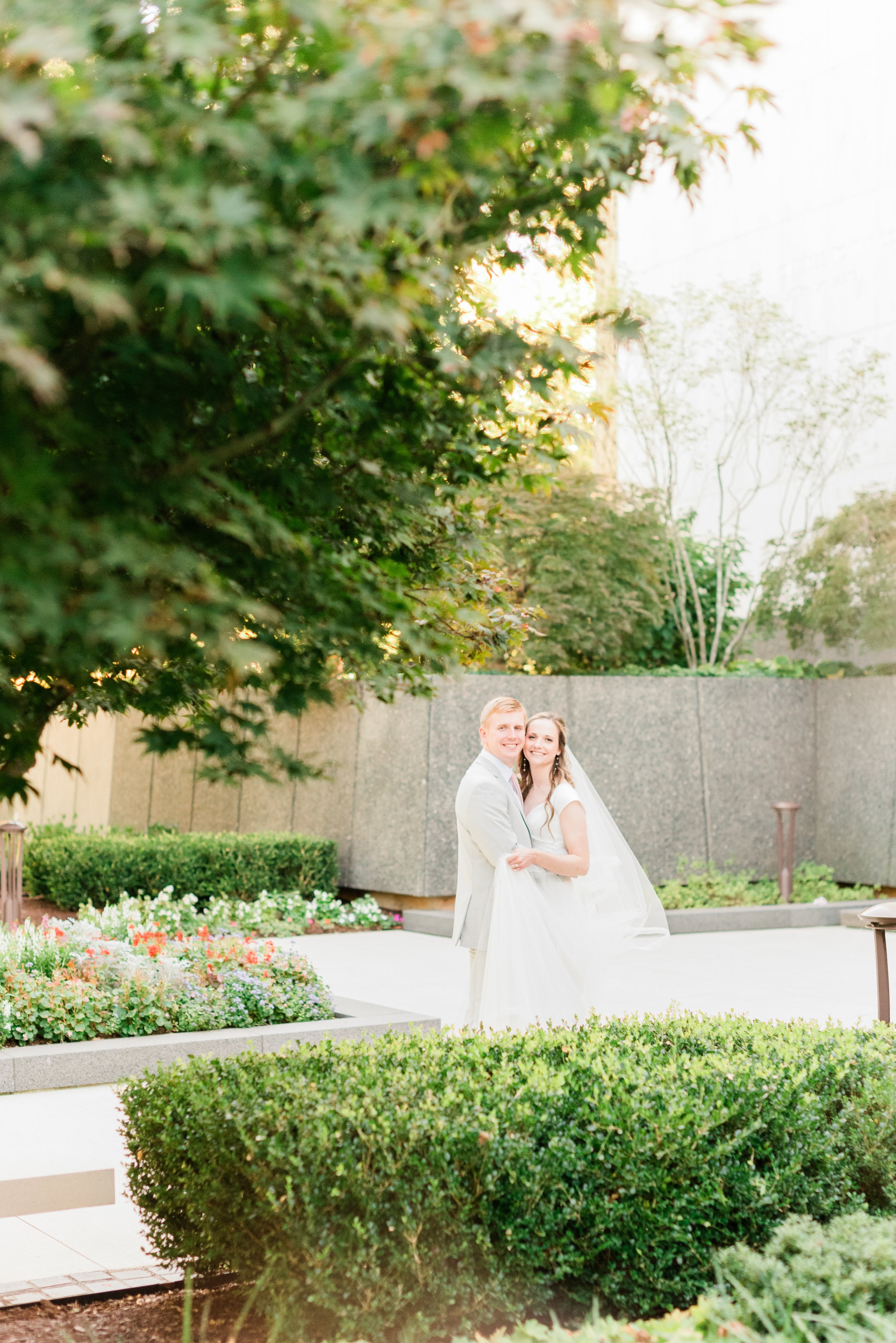  A happy new bride and groom pose for newlywed photos on the Atlanta LDS temple grounds. #marylandweddingphotographer #atlantaweddingphotographer #brideandgroom #justmarriedphotos #bridalportraits #weddingdayphotos #LDSweddingphotographer #templegrou