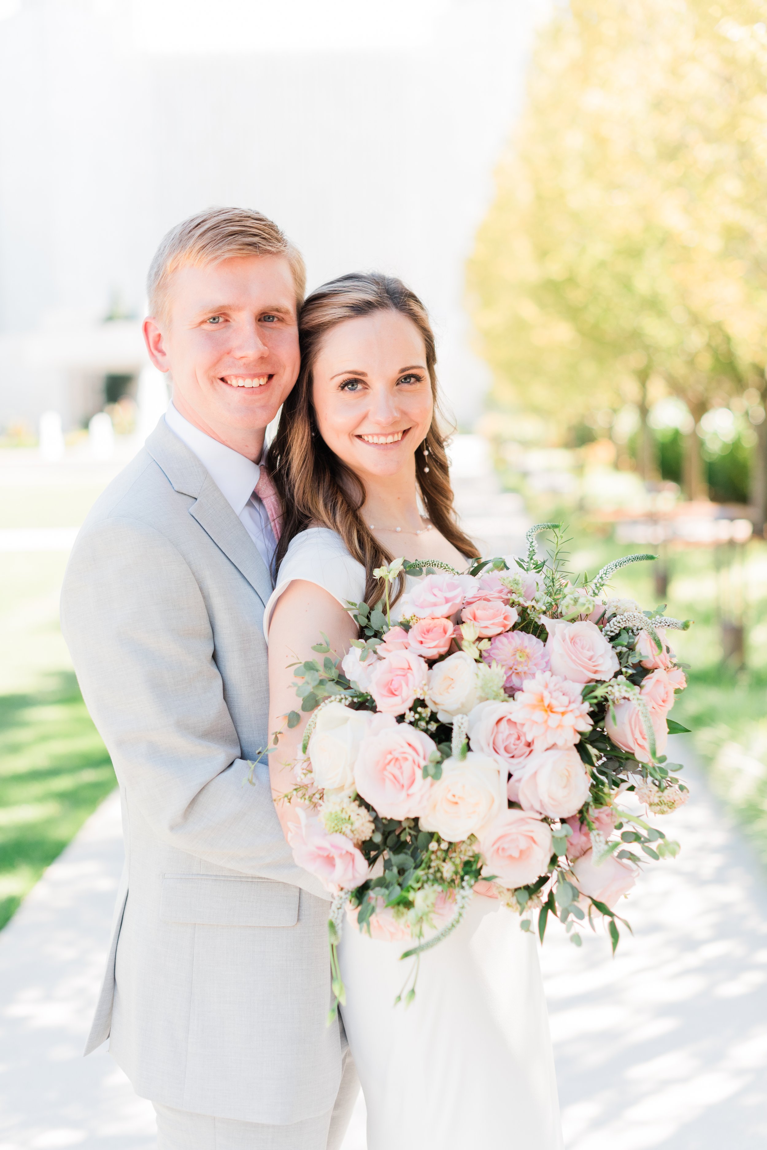  &nbsp;This newlywed bride poses with her stunning bouquet of blush and white roses in just married photos with her new husband at the Atlanta temple grounds. #marylandweddingphotographer #atlantaweddingphotographer #brideandgroom #justmarriedphotos 