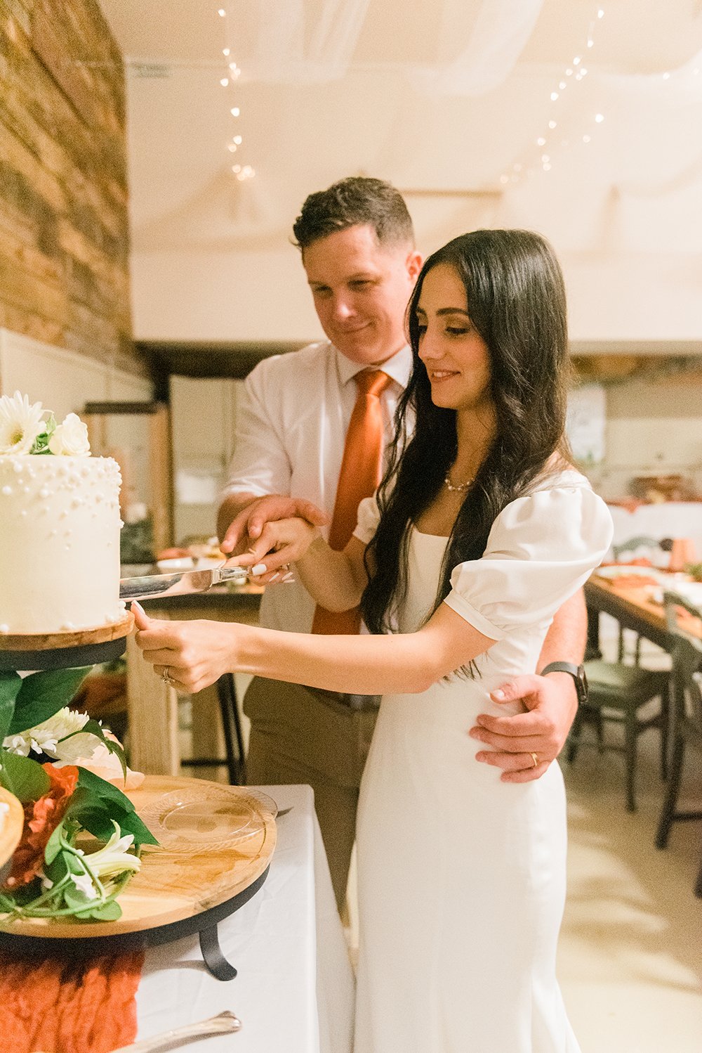  A bride and groom cut their wedding cake together at their reception photographed by Jacquie Erickson, an Atlanta-based wedding photographer. wedding must-haves document your wedding #atlantaweddingphotographer #memorablewedding #weddingparty #georg