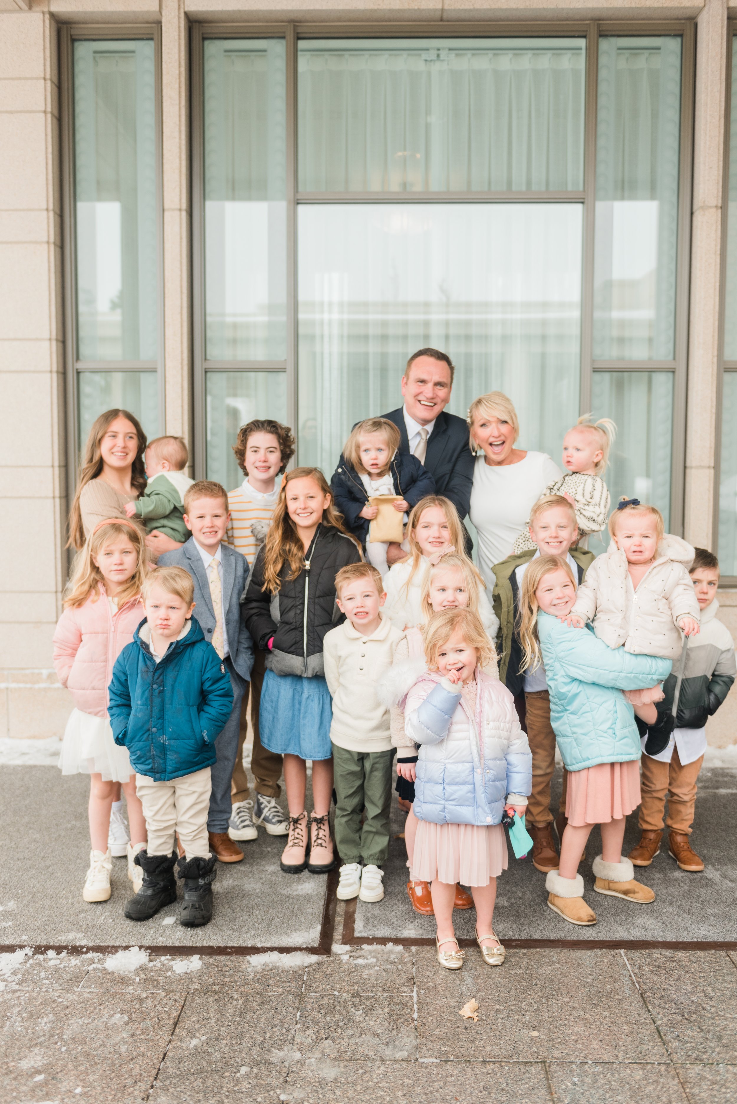 A bride and groom pose with their grandchildren in front of the Rexburg, ID LDS temple on their wedding day. Family wedding photos wedding photography timeline grandchildren photo #weddingphotographytimeline #stressfreeweddingday #ldswedding #photog