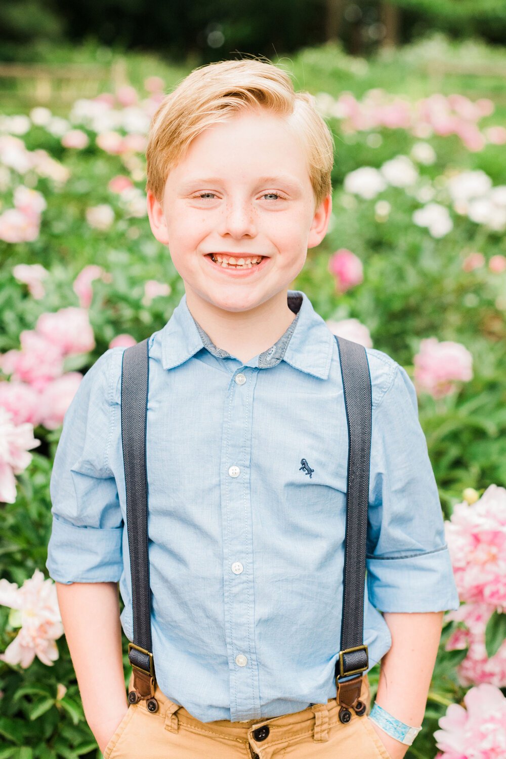  A little boy in blue suspenders smiles brightly in a portrait captured by Jacquie Erickson, an Atlanta-based photographer Marietta Sandy Springs Sharpsburg&nbsp; Roswell Children's portraits capture their childhood #childportraits #childrenphotograp