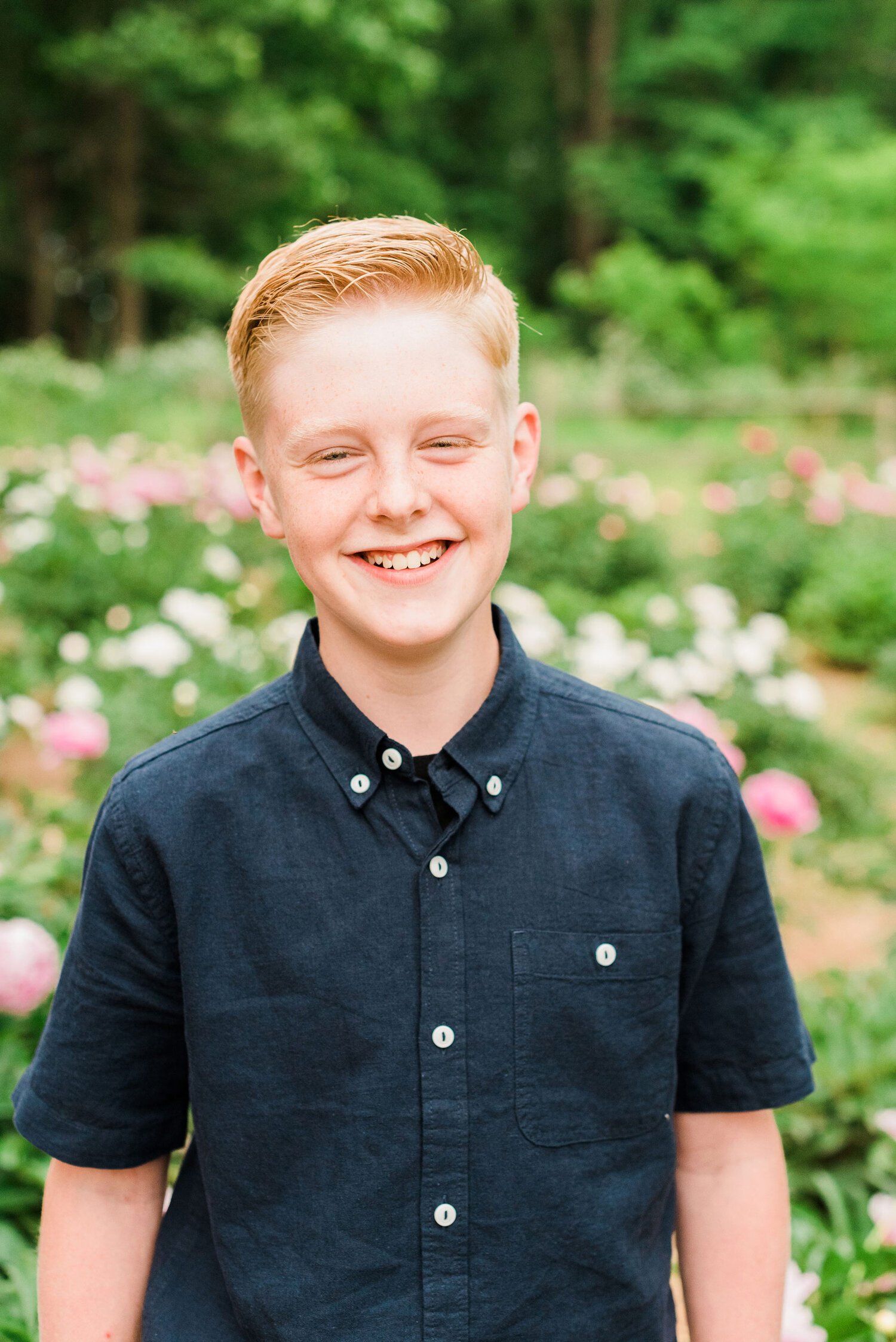  A young man in a button-up blue shirt smiles for a portrait captured by Jacquie Erickson. Personalized kid's portraits capture their childhood Fayetteville Peachtree City&nbsp; #childportraits #childrenphotographer #georgiaphotographer 