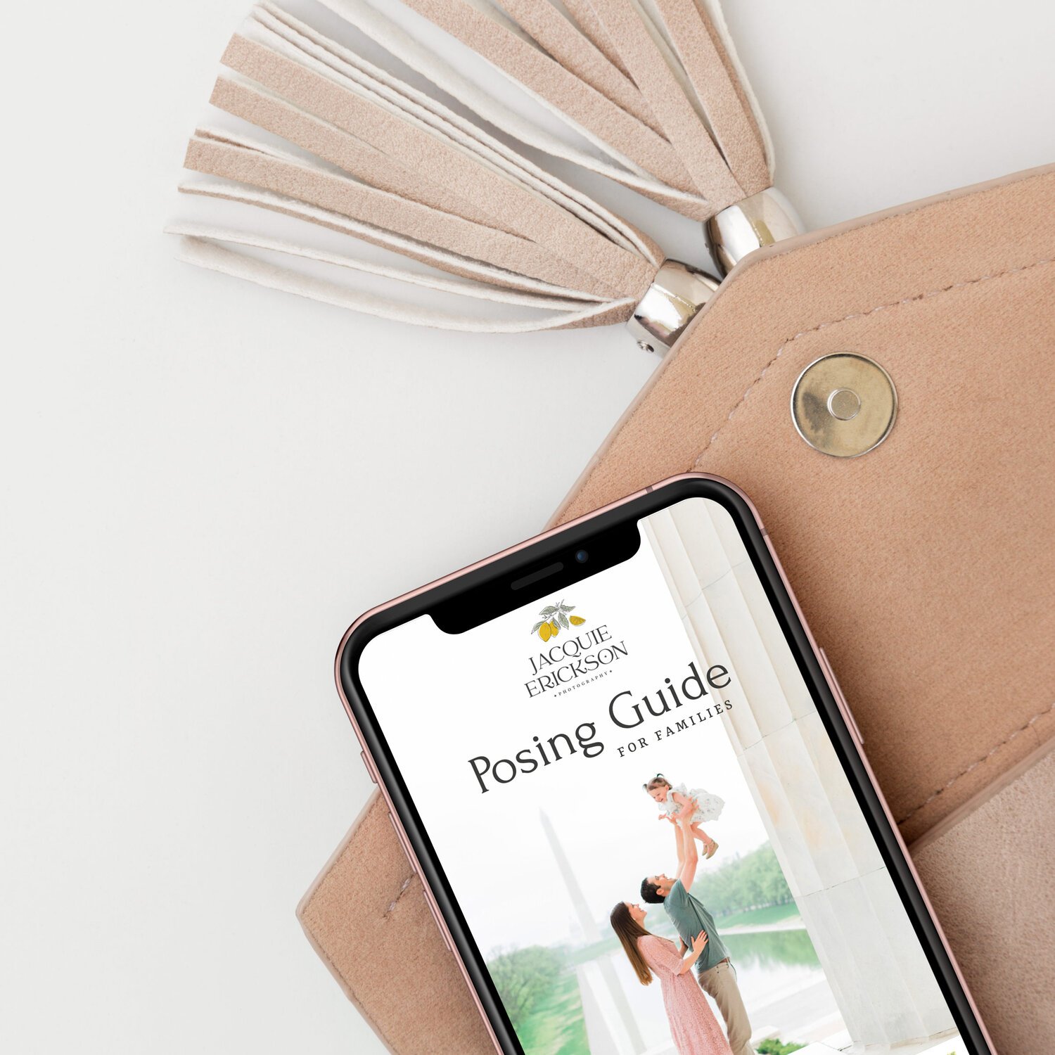  An iPhone rests on a clutch open to a posing guide, a website by Jacquie Erickson Atlanta-based photographer. Client questionnaire Momtog course streamline workflow small business helpers #planoly #dubsado #pixiset #tailwind #theunburdenstudio #phot