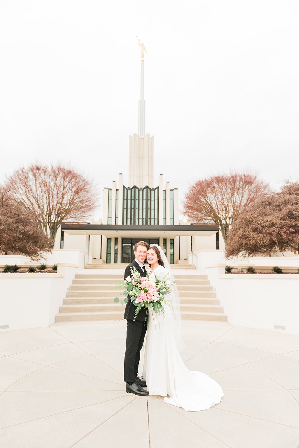  A wide shot of a newlywed couple in front of the Atlanta, Georgia LDS temple. Professional wedding photographer temple wedding pictures#peachtreecity #weddingphotographer #ldsweddings #atlantatemple #jacquieerickson 