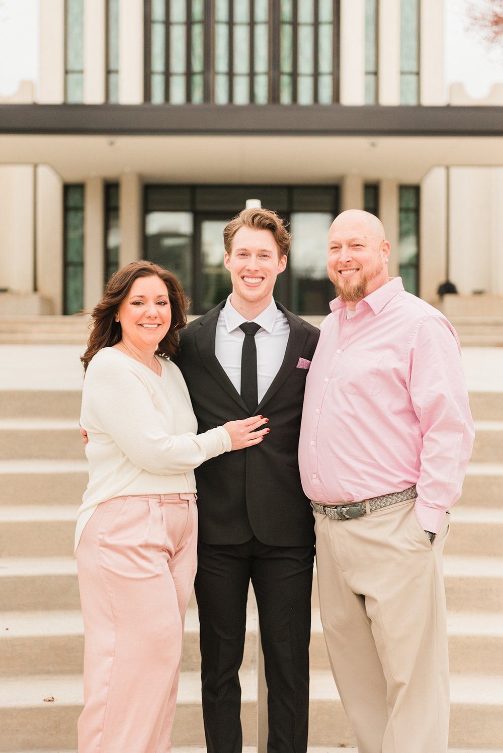  A groom stands with his mom and dad in front of the Atlanta, Georgia LDS temple. wedding photographer Atlanta photographer Sharpsburg Roswell #weddingphotographer #ldsweddings #atlantatemple #jacquieerickson #parentsofthegroomphoto 