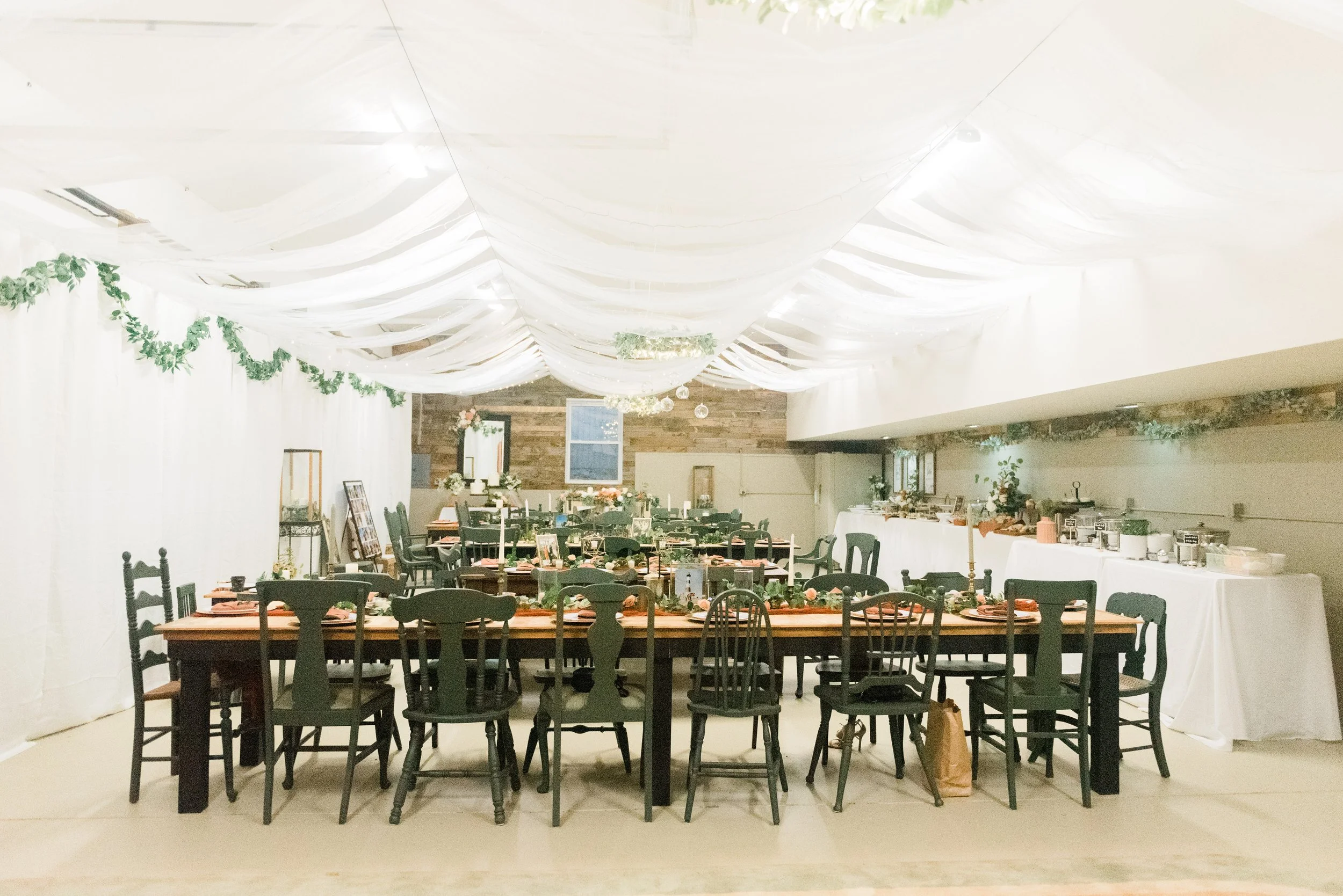 Cozy wedding luncheon with long tables, black mismatched chairs, and wooden walls by Jacquie Erickson Photography. wedding lunch #JacquieEricksonPhotography #JacquieEricksonWeddings #DCLDSTemple #DCwedding #WinterWeddingDC #DCweddingphotographer