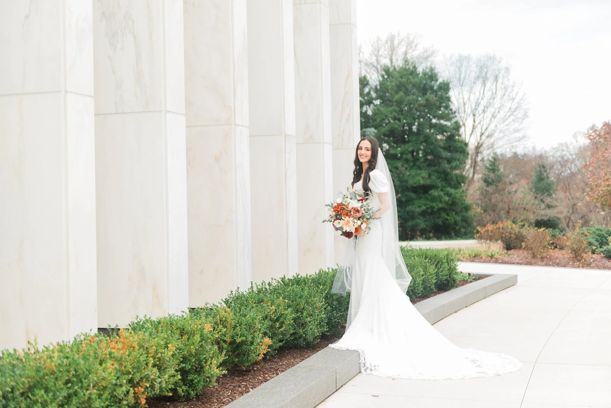 Bride standing outside the DC LDS Temple on her wedding day captured by Jacquie Erickson Photography. winter wedding #JacquieEricksonPhotography #JacquieEricksonWeddings #DCLDSTemple #DCwedding #WinterWeddingDC #DCweddingphotographer