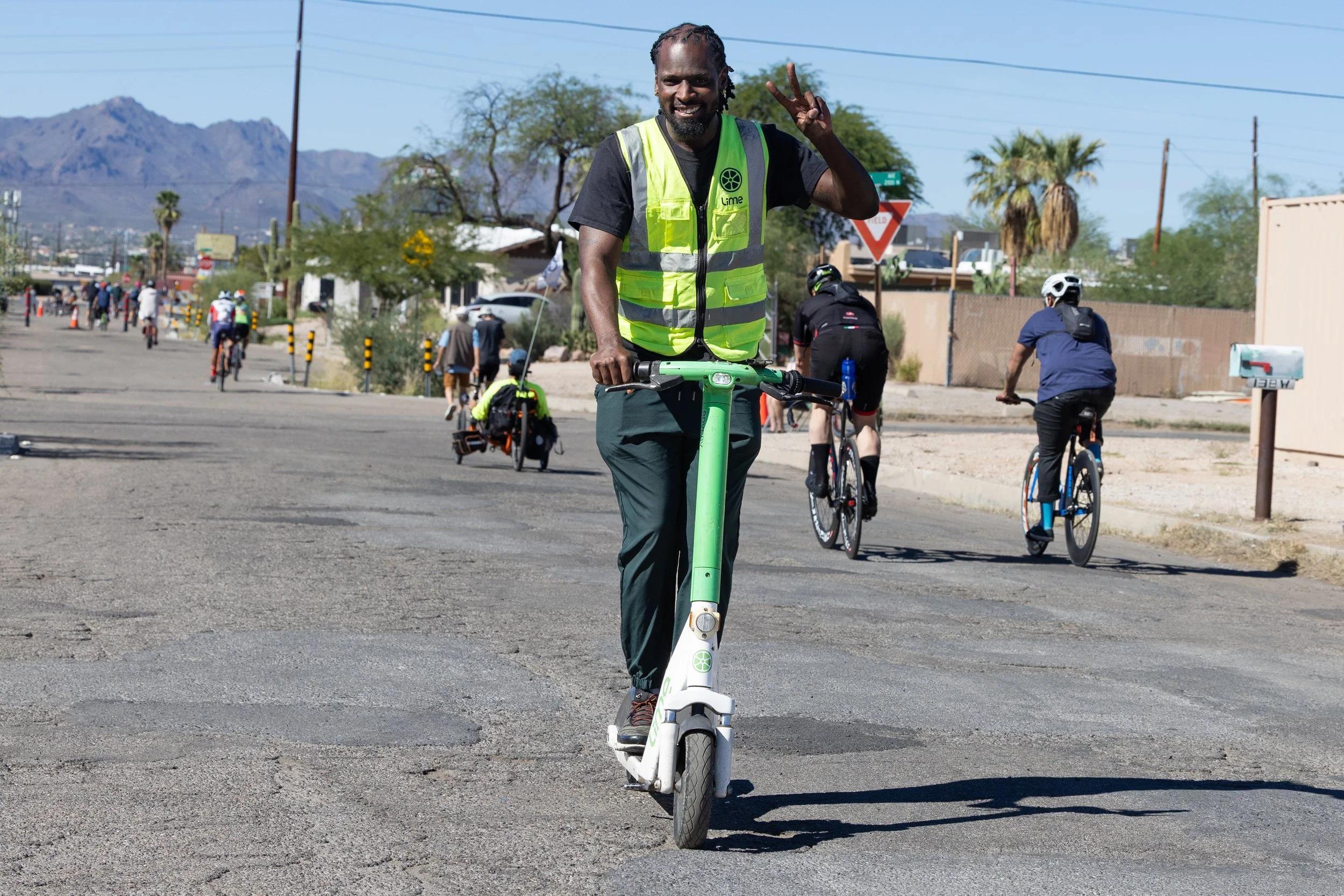 Person riding a Lime Scooter on a Tucson street