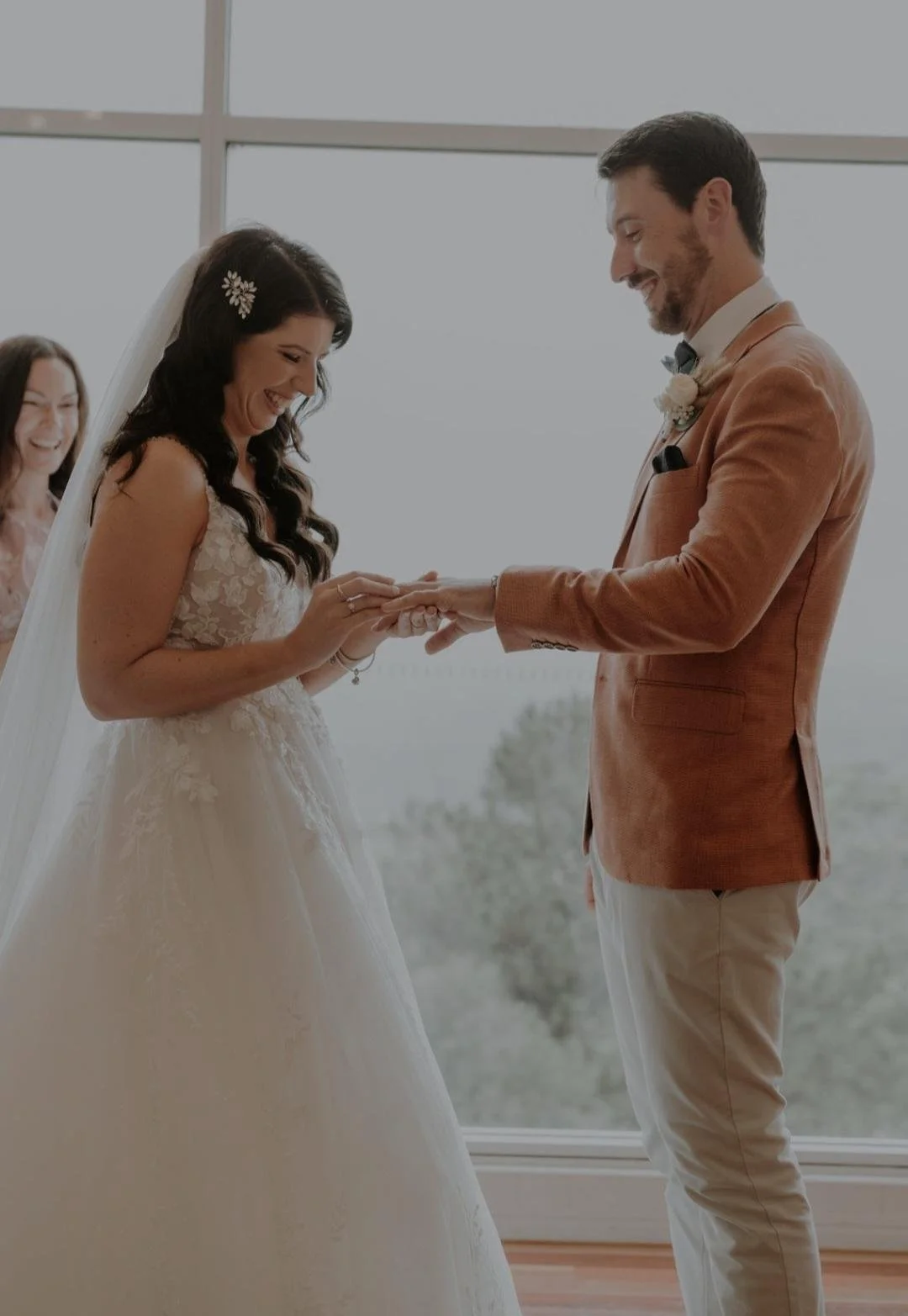 bride putting wedding ring on groom's finger.jpg