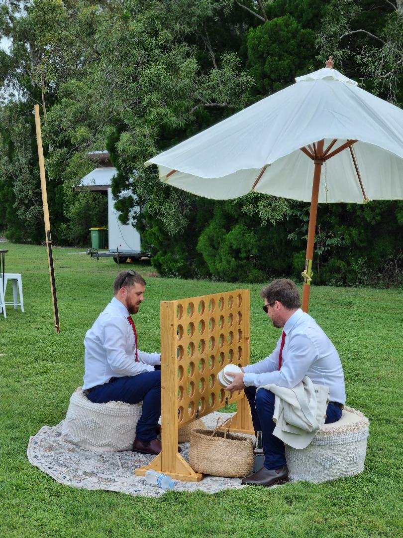 best man and groom playing connect 4 at wedding.jpg