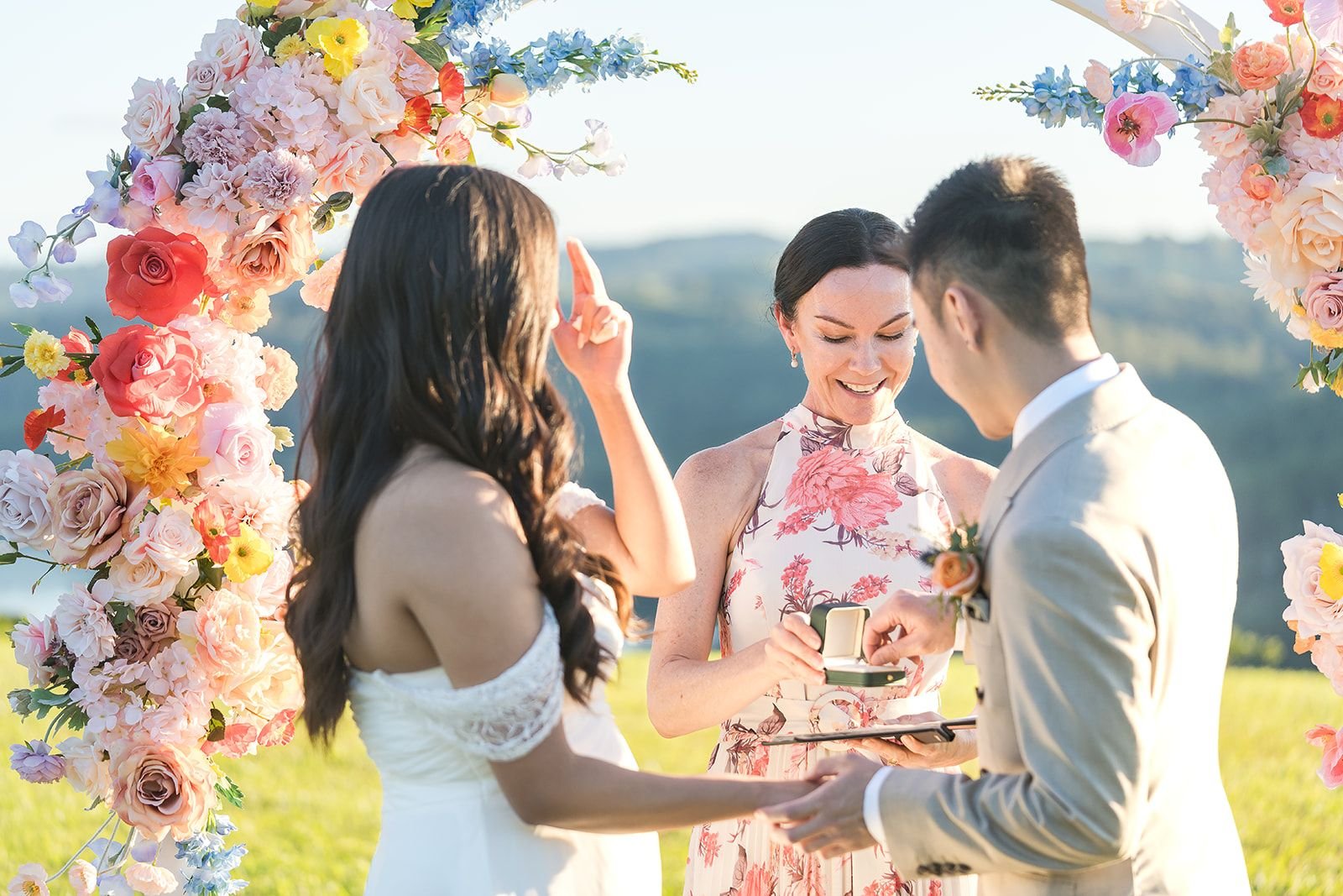 celebrant-presenting-wedding-ring-to-groom-during-marriage-ceremony