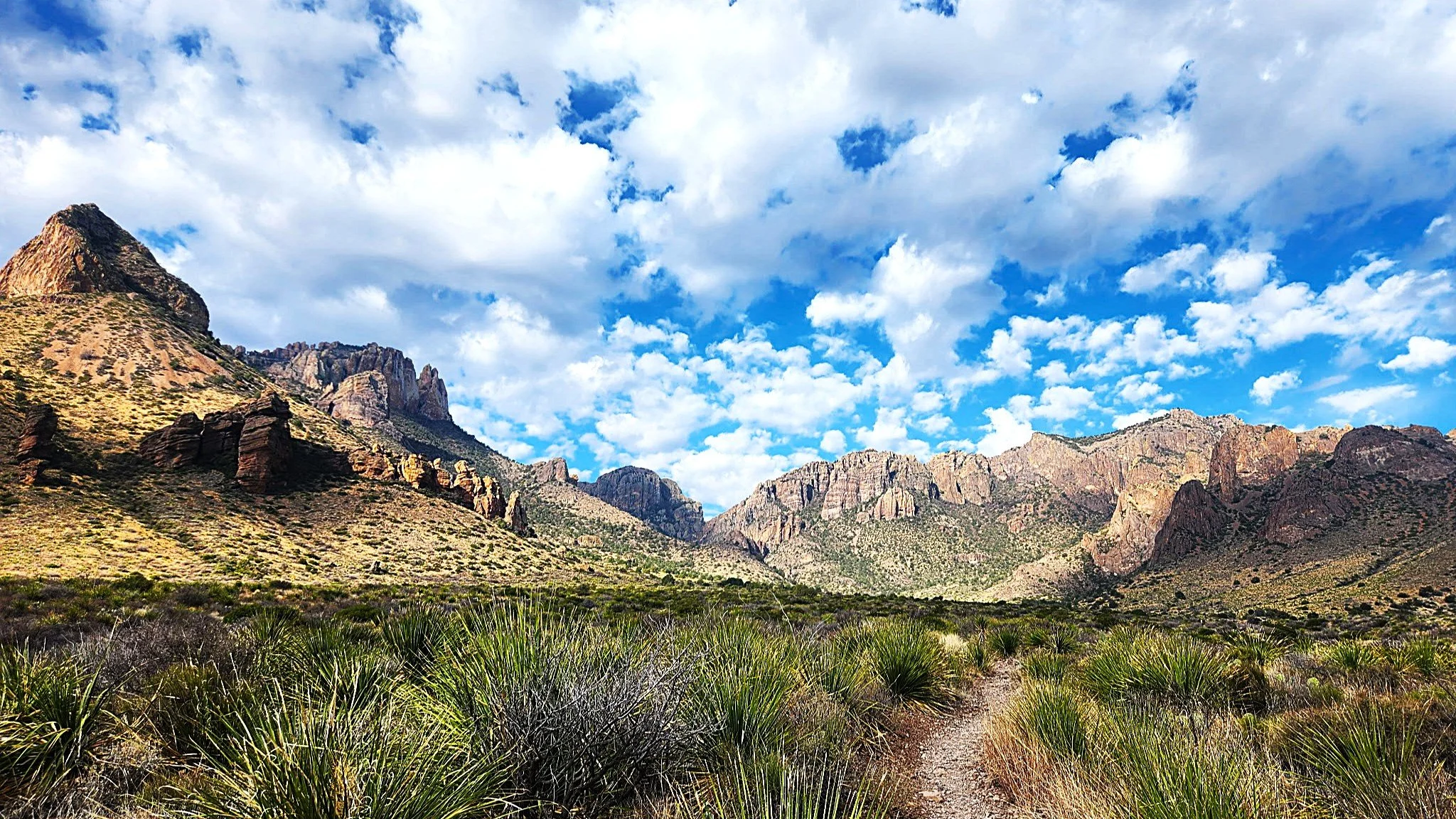 Desert mountains and blue sky with white clouds