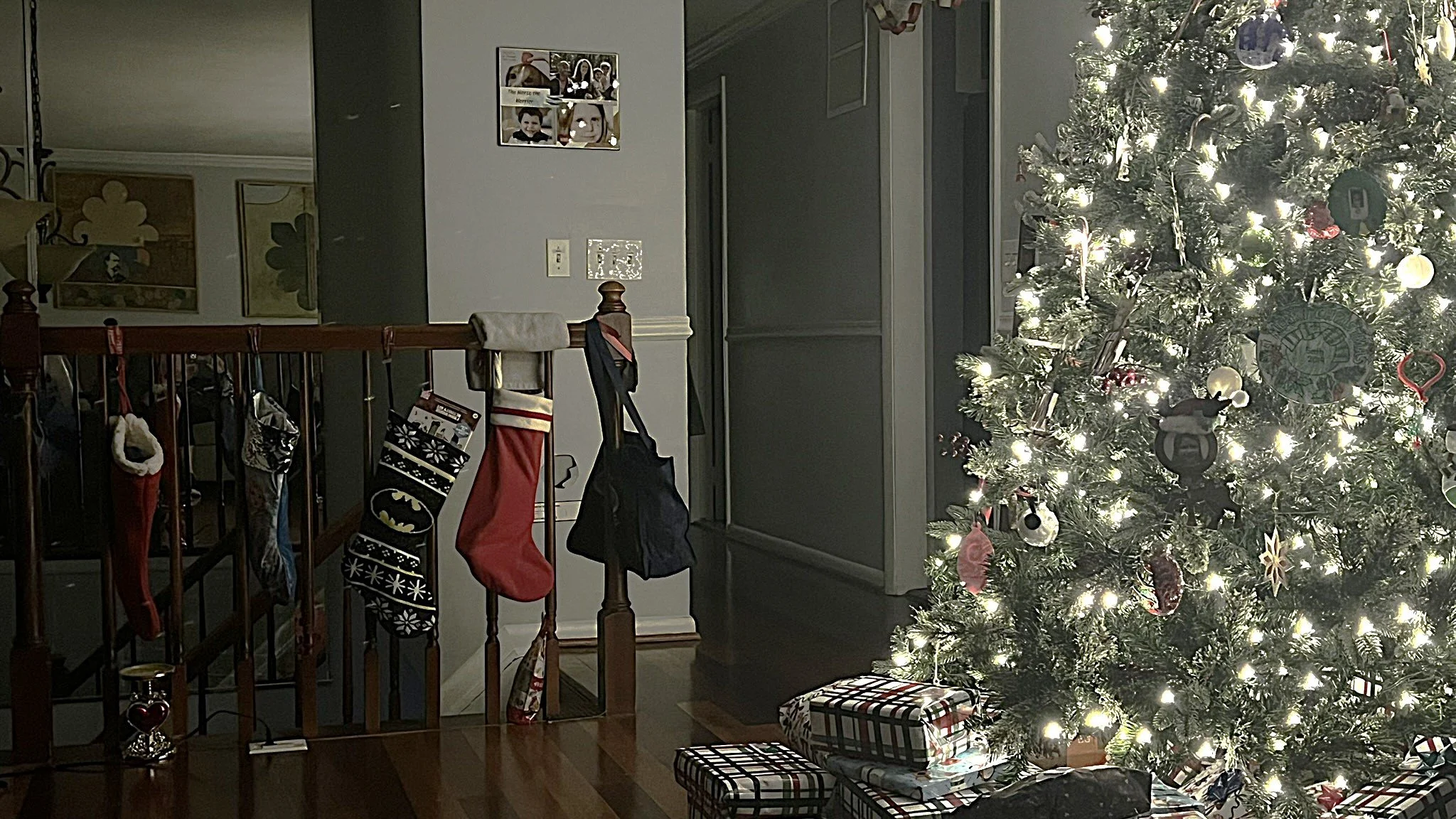 A Christmas tree well lit, with stockings hung with care.