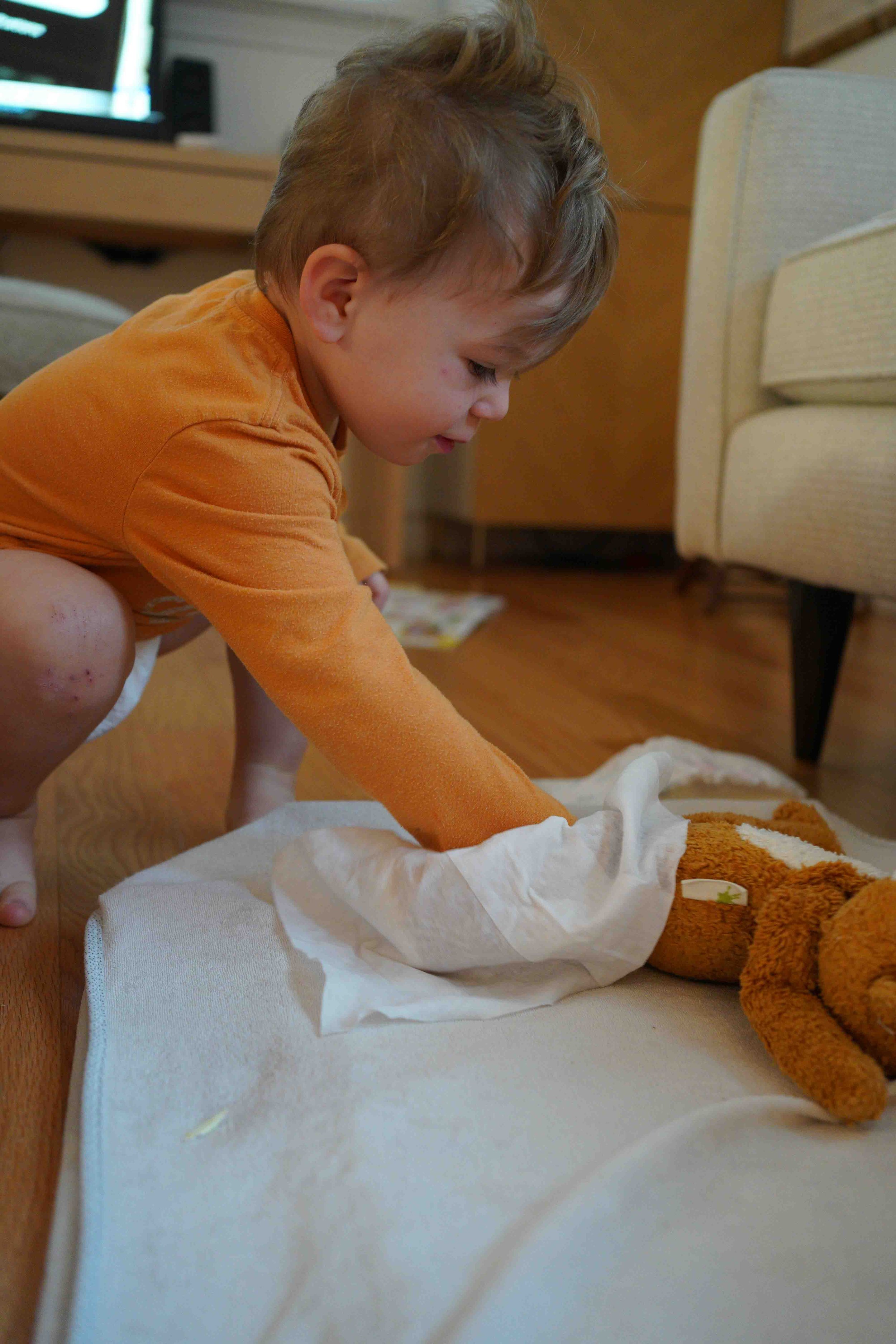 Jack is changing Bear's diaper