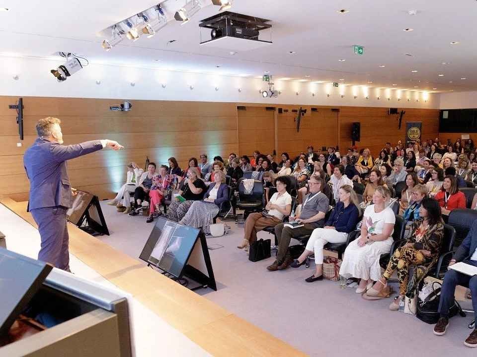 Anthony delivering a keynote to a packed conference hall