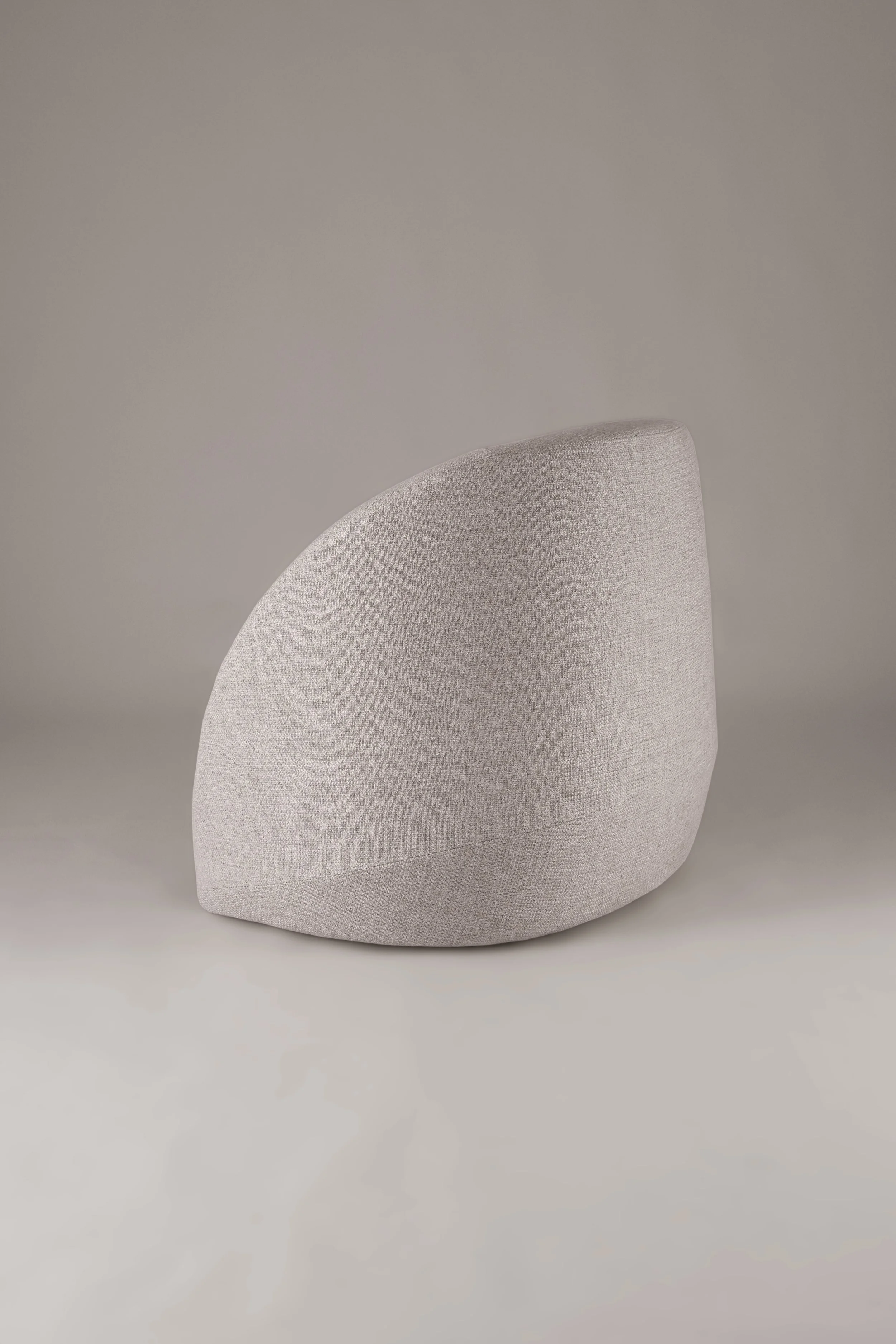 Rear view of the Petal armchair, highlighting the clean, continuous curved backrest designed to float effortlessly in space.