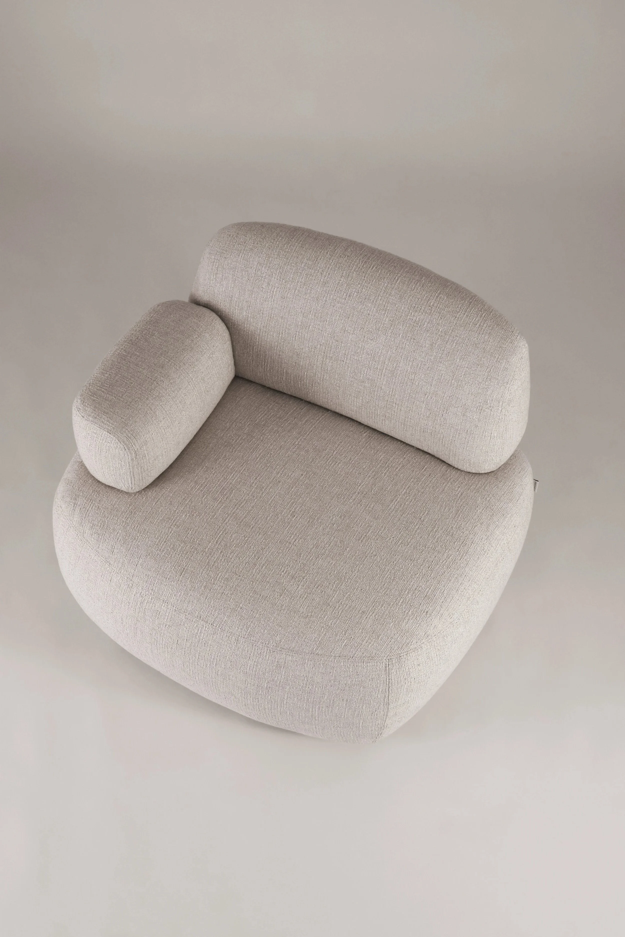 Top-down perspective of the Sekitei armchair, illustrating the generous rounded seat and the versatile single armrest layout.