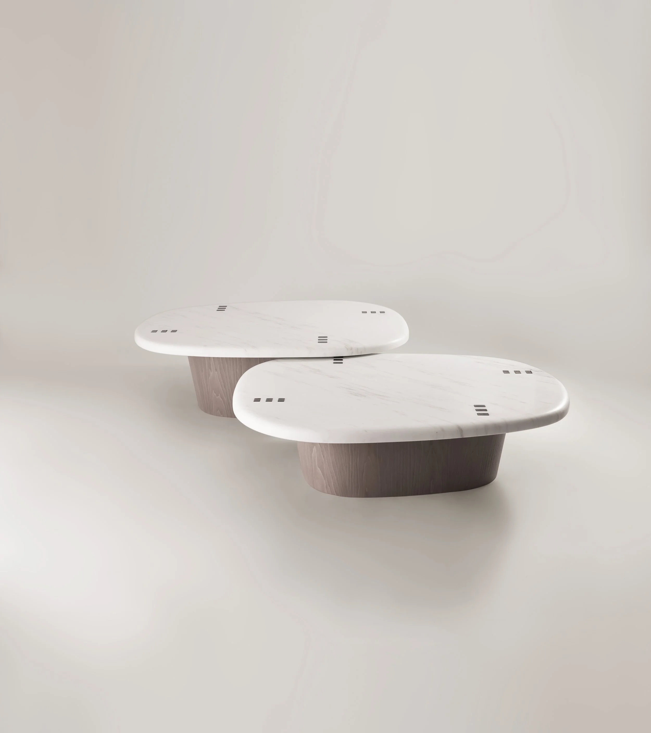 Complete set of the Pebble coffee tables in a minimalist setting, illustrating the river-stone inspired design and fluid arrangement.