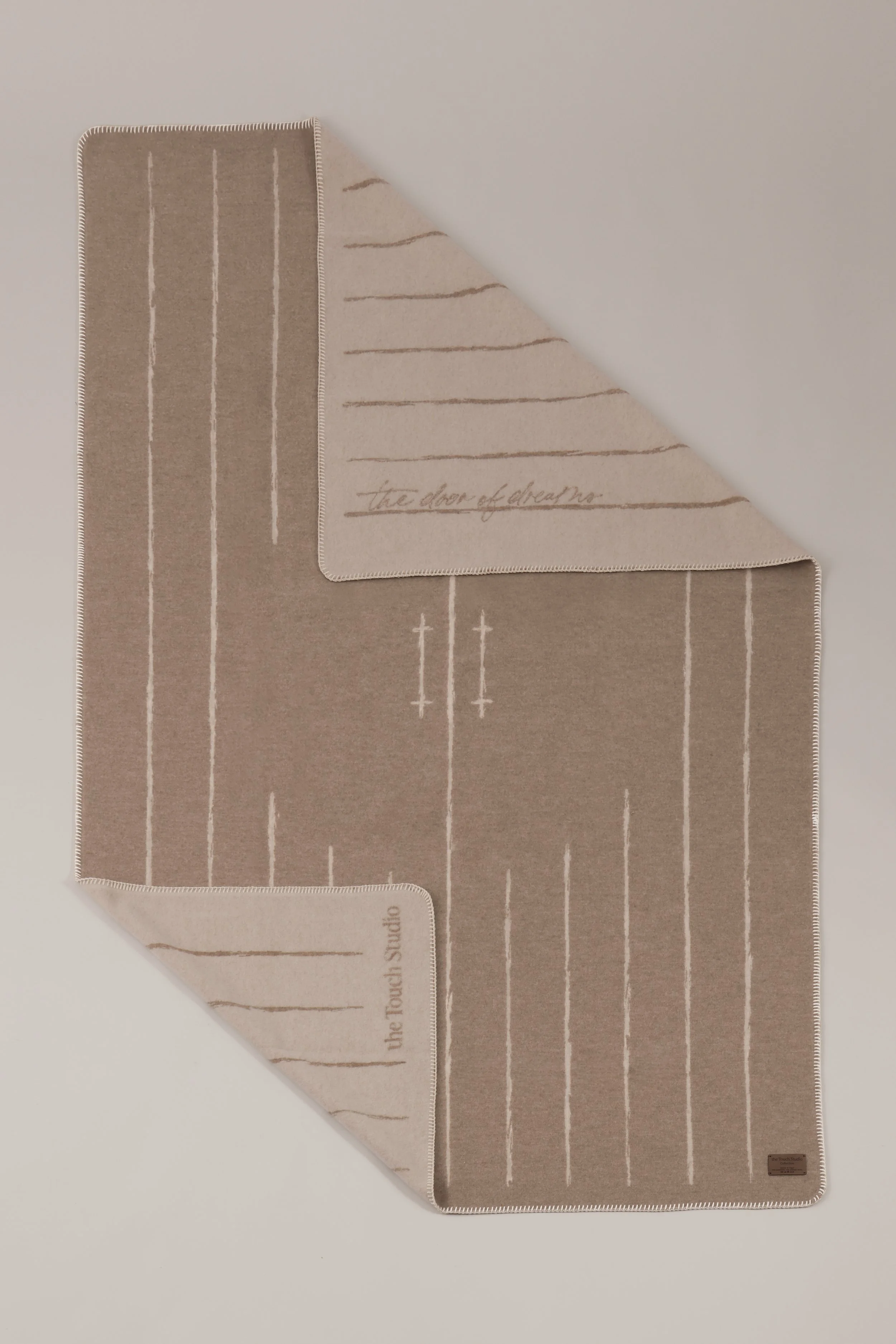 Two-tone reversible luxury plaid in camel and ecru, 90% merino 10% cashmere blend.