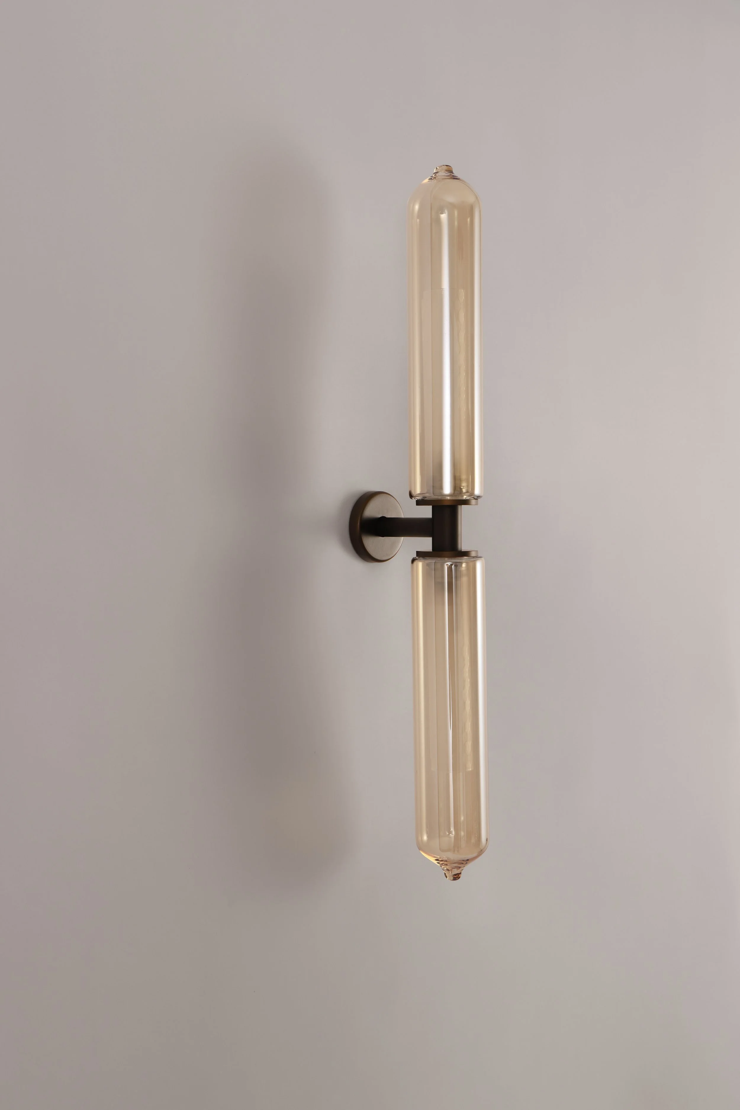 Full vertical view of the modern Bee Applique wall lamp, handcrafted in Italy with double hand-blown bronze glass and a dark brushed bronze finish.