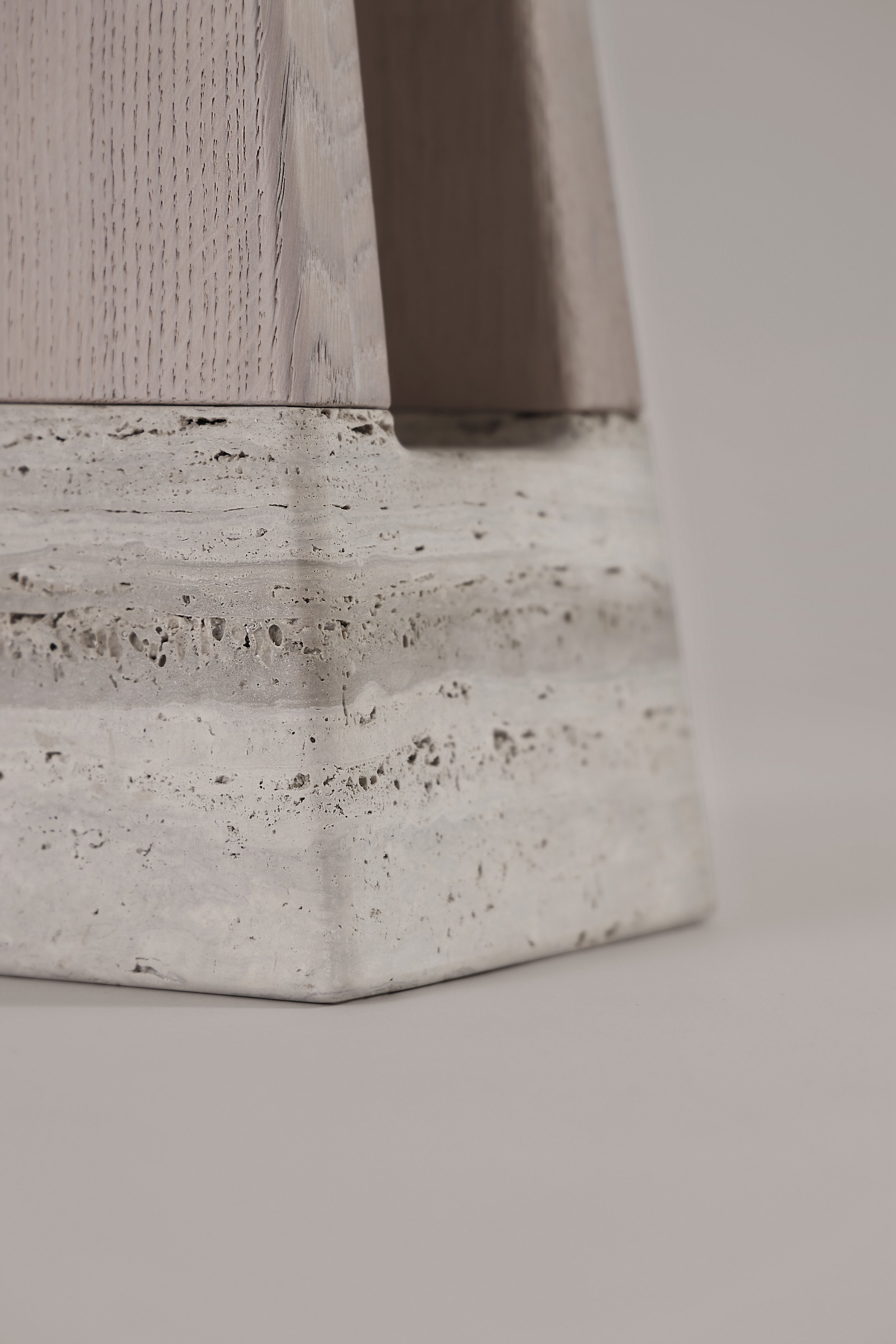 Detailed close-up of the raw, porous texture of the natural Silver Travertine base, a signature of authentic materials in the Bring Me table.
