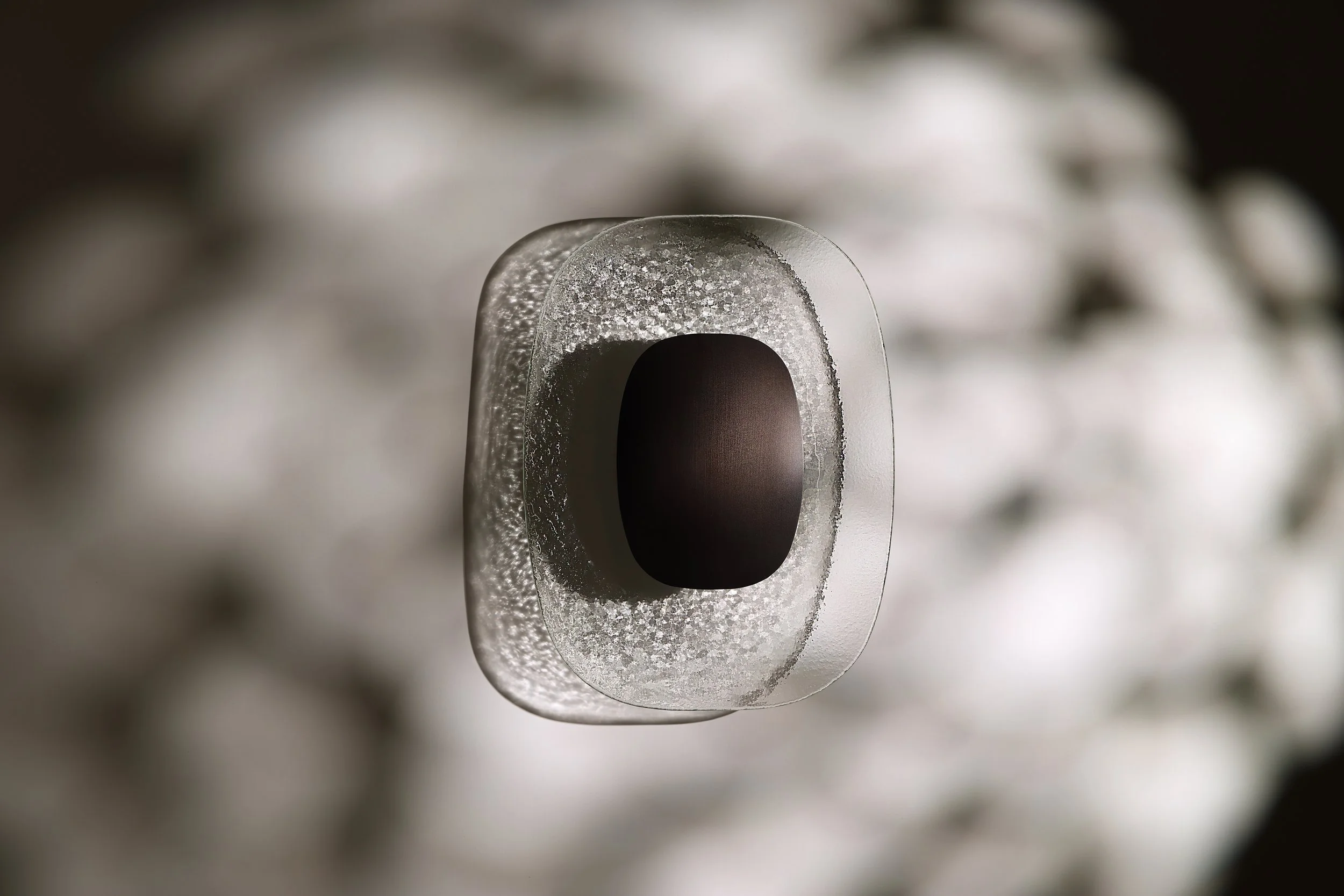 The signature light projection of the Drop Light, transforming a vertical surface into a poetic ripple of water and light