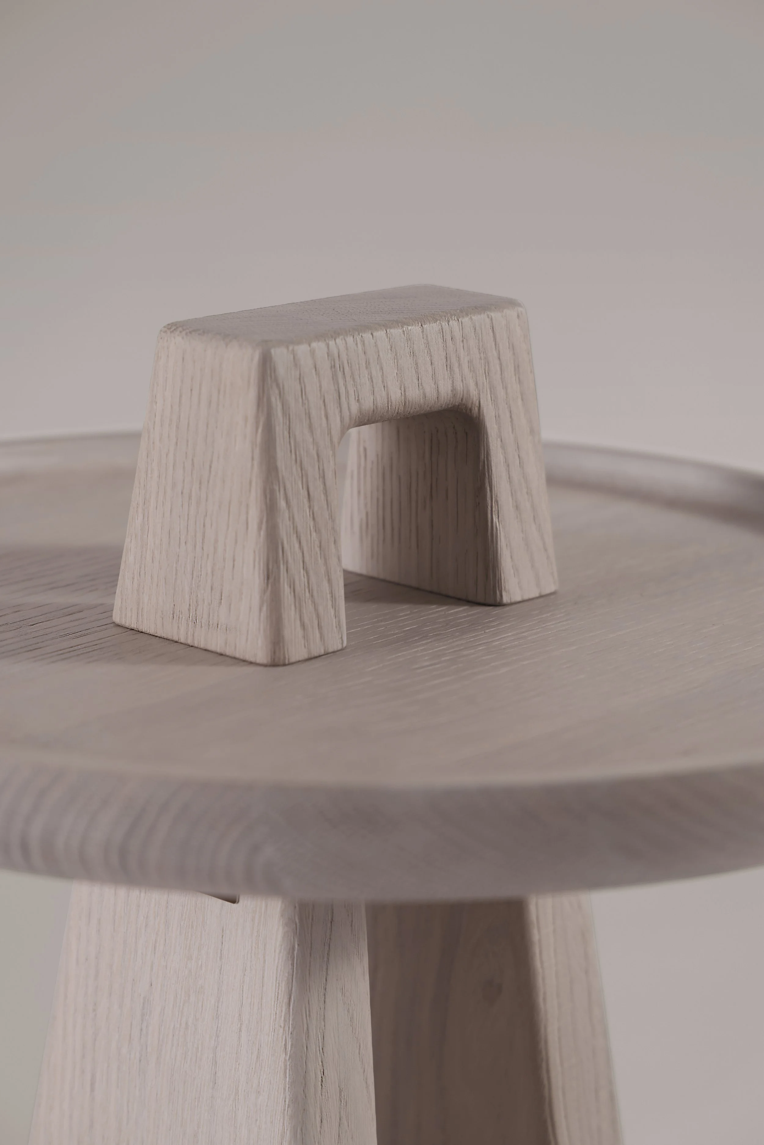 Detail of the light brushed oak wood surface of the Bring Me table, showing the hand-finished tactile quality