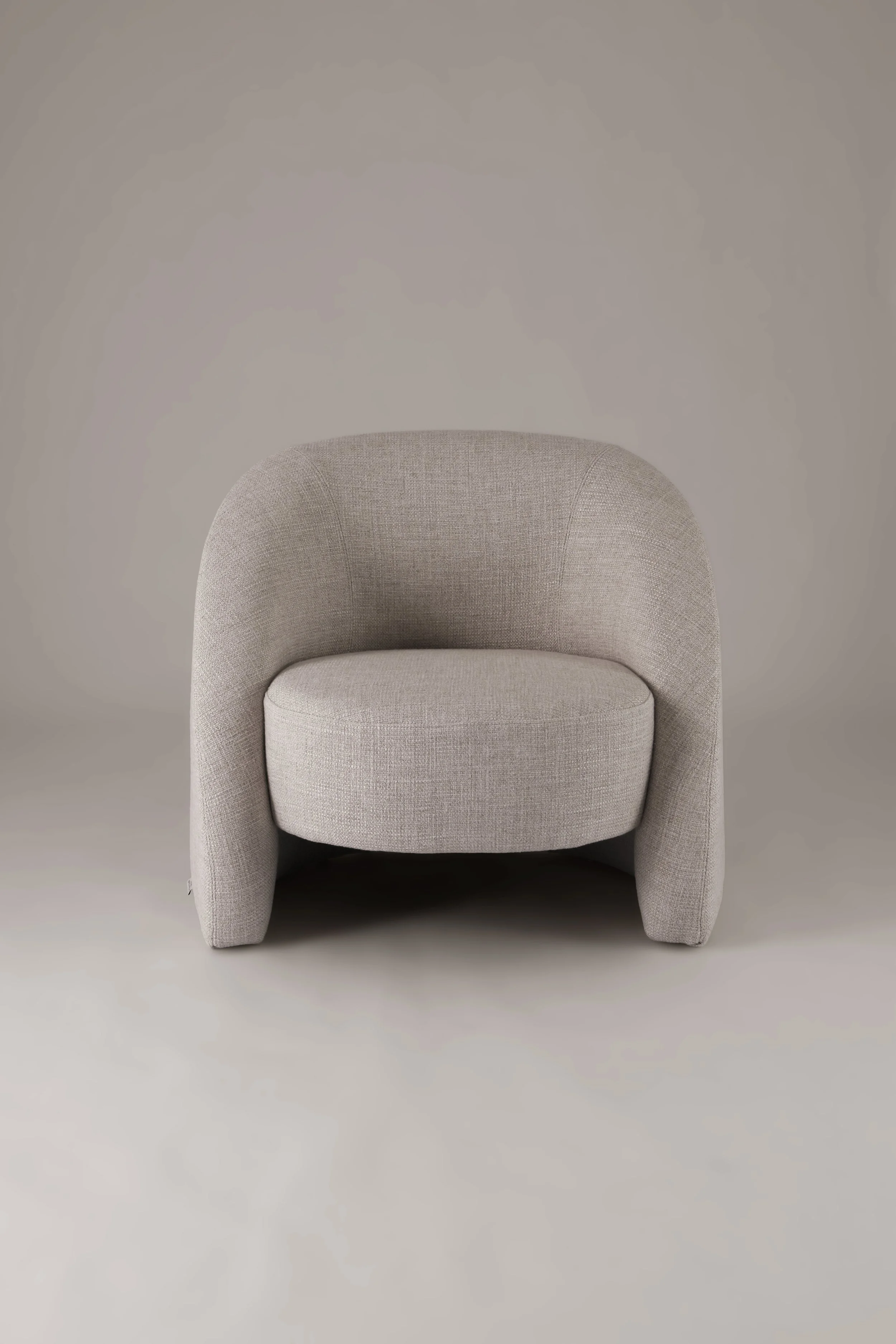 Symmetrical front view of the Petal armchair, demonstrating how the welcoming form gently cradles the body.