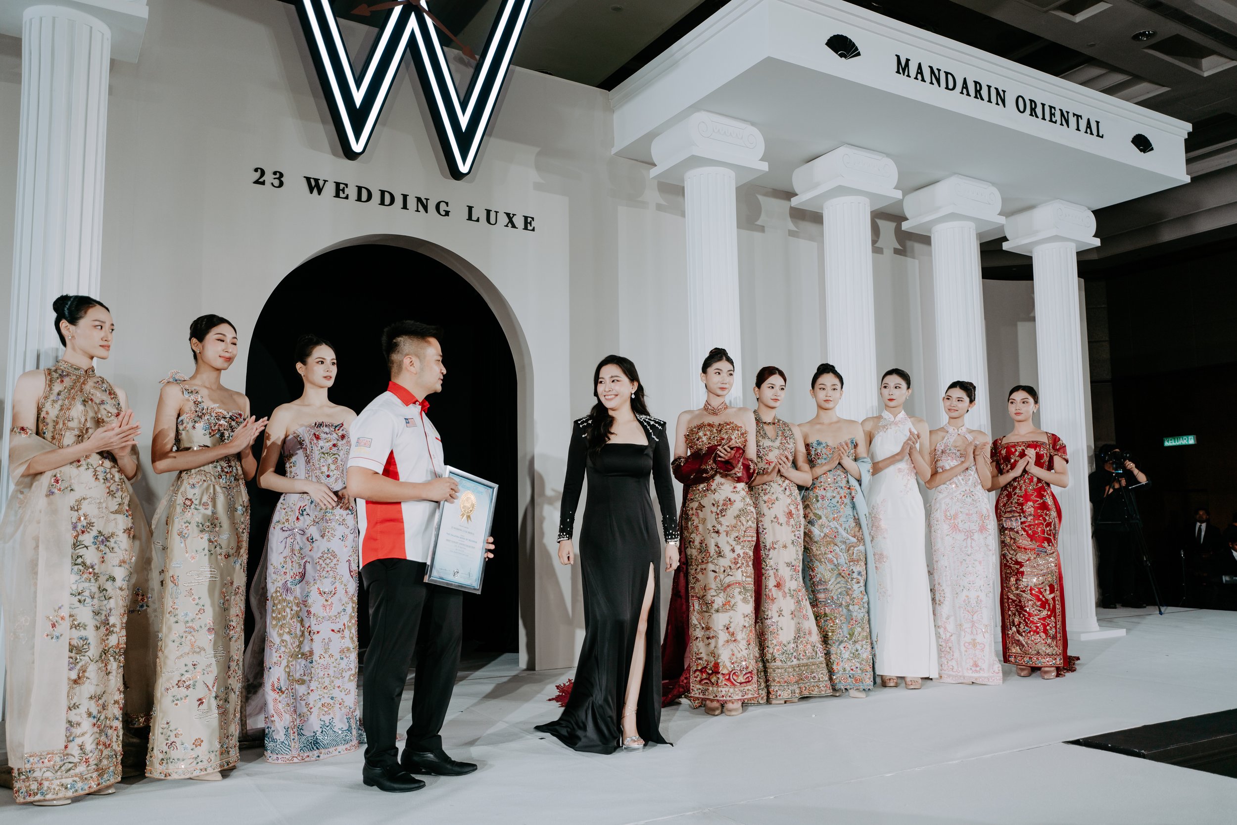 23 Wedding Luxe designer receiving the Malaysia Book of Records award with brides in Sangjit gowns