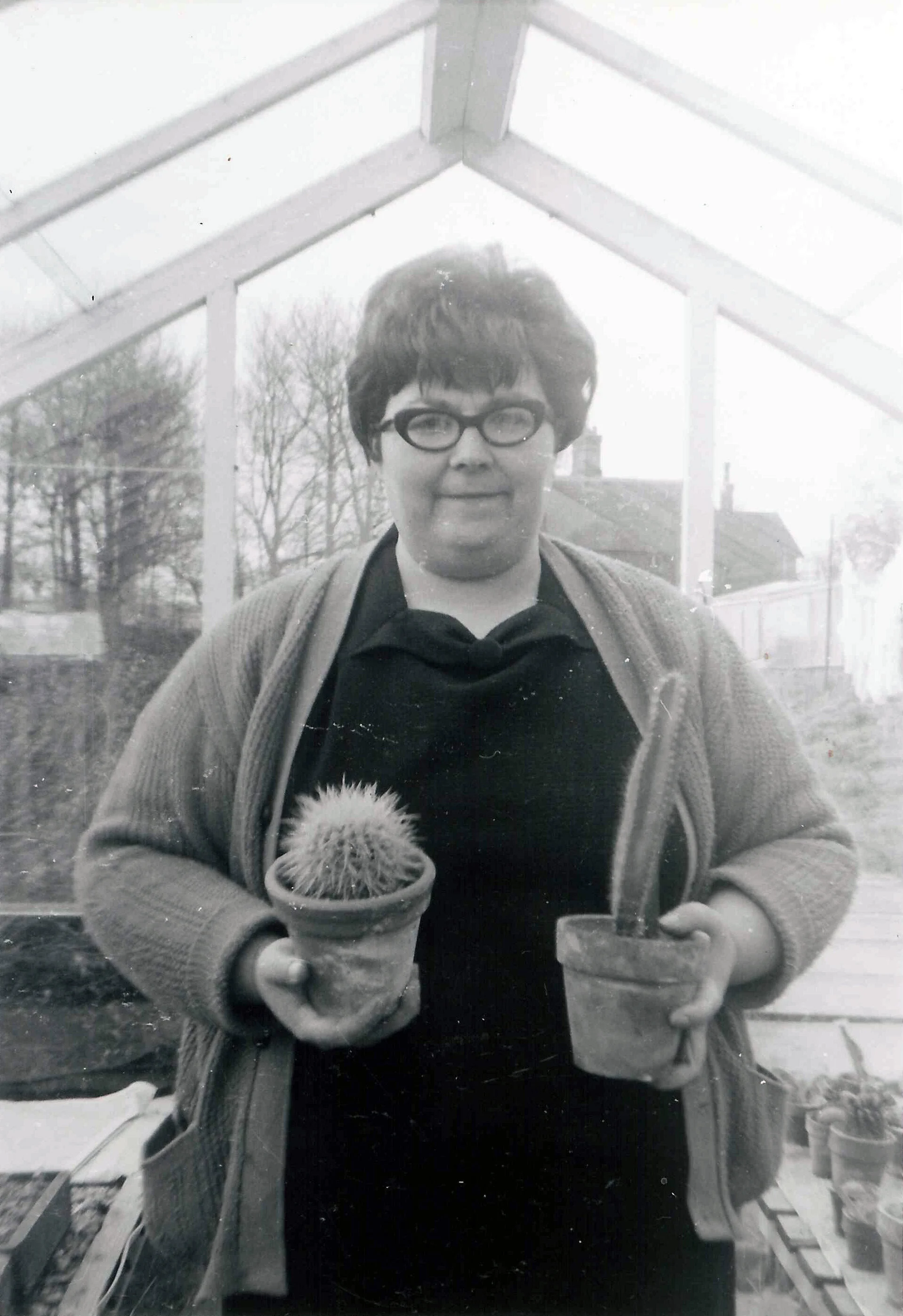 Grace Russ in greenhouse with cacti