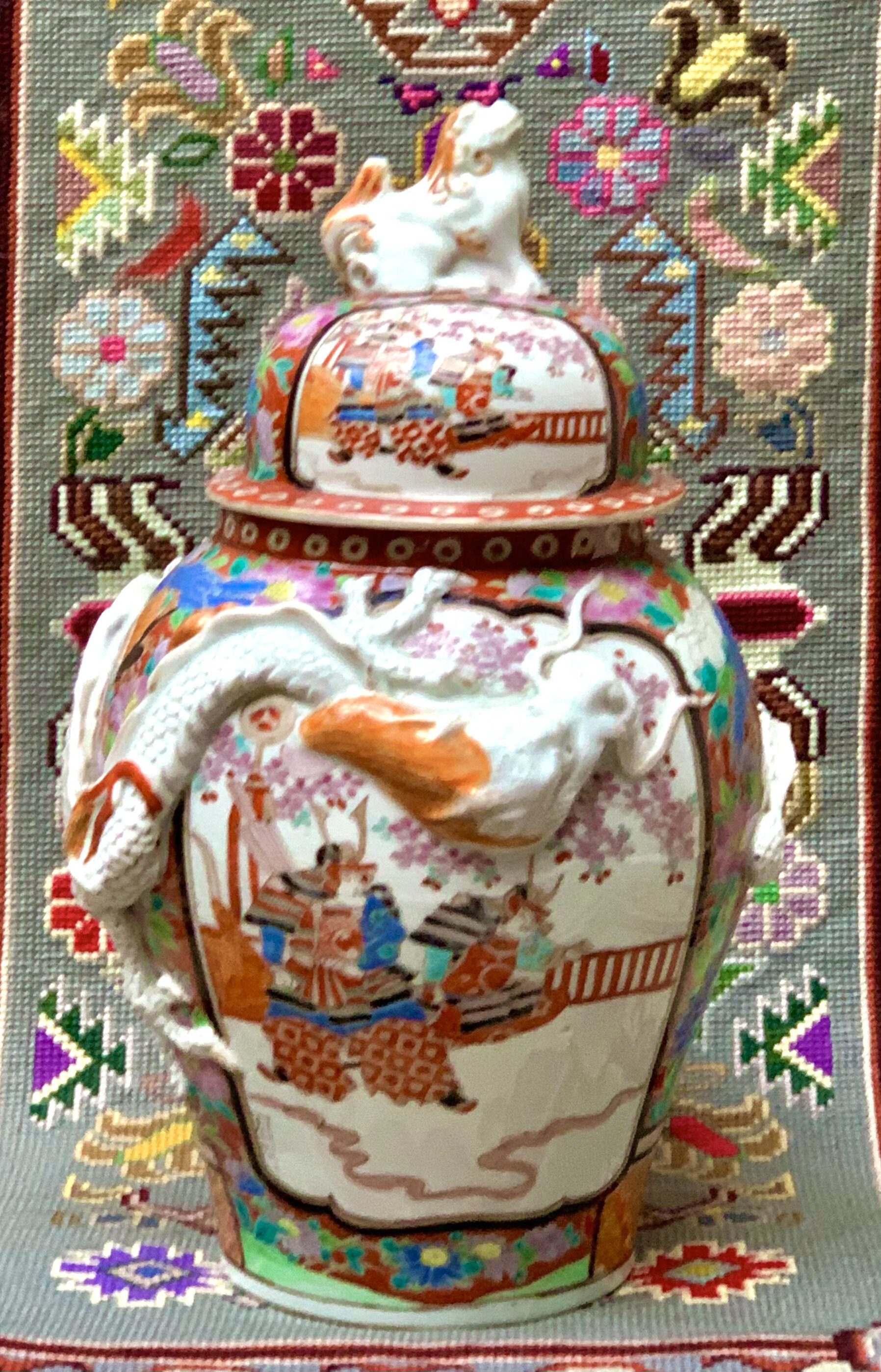 A 19th Century Japanese hand painted Imari Ginger Jar with a Foo Dog Finial. A more unusual example with the overlaid Dragon, in a fine condition. Height 35 cm, Diameter 22 cm. Price on Application