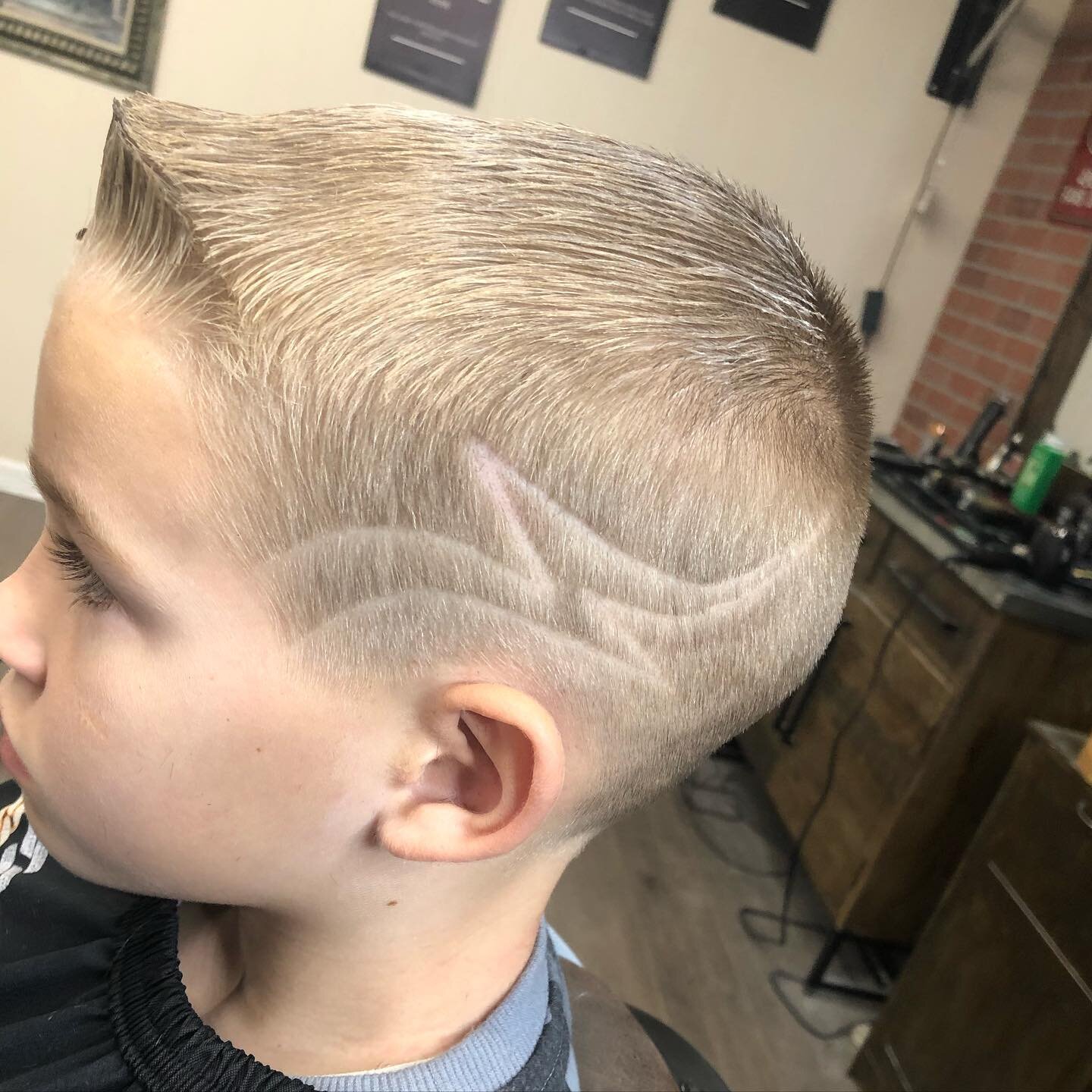 Tag team hair cut! Lightning bolt design by Phil. Fade by Elijah. Book your holiday cut with us today!!