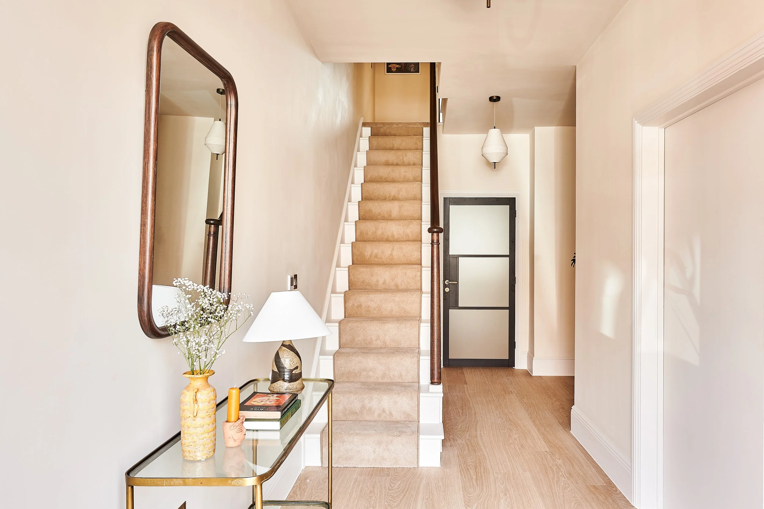 Elegant hallway of Victorian terrace with oak flooring, stair runner and French polished hand rail. Crittall style door to WC. 