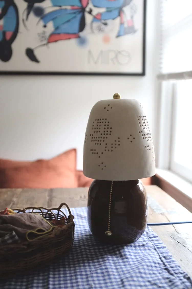  Martina Thornhill Rose Punched Shade Lamp - $398   
I'm obsessed with this ceramics-meets-lace lamp and the light it casts.. pure perfection! 