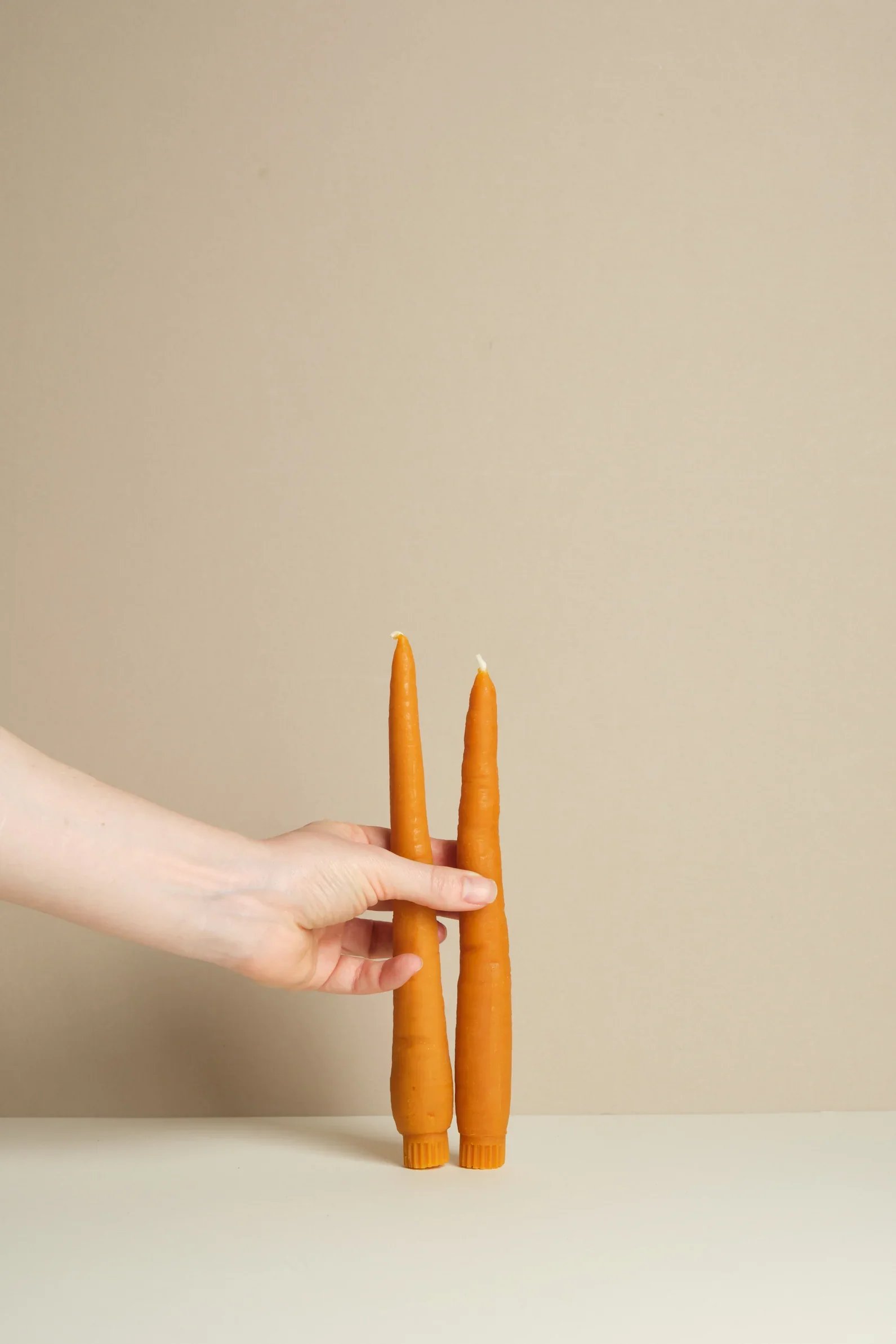  Popham’s Home Carrot Beeswax Candlesticks - £25  
Pophams can do no wrong.. from pastries to homewares, these would bring playful charm to any table