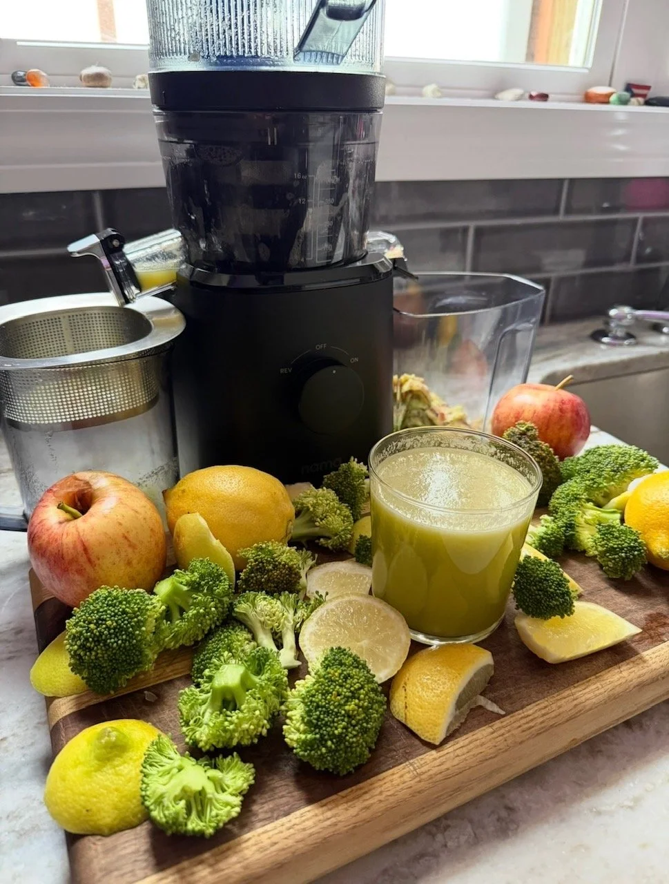 Woman drinking green juice for perimenopause body odor and hormonal wellness